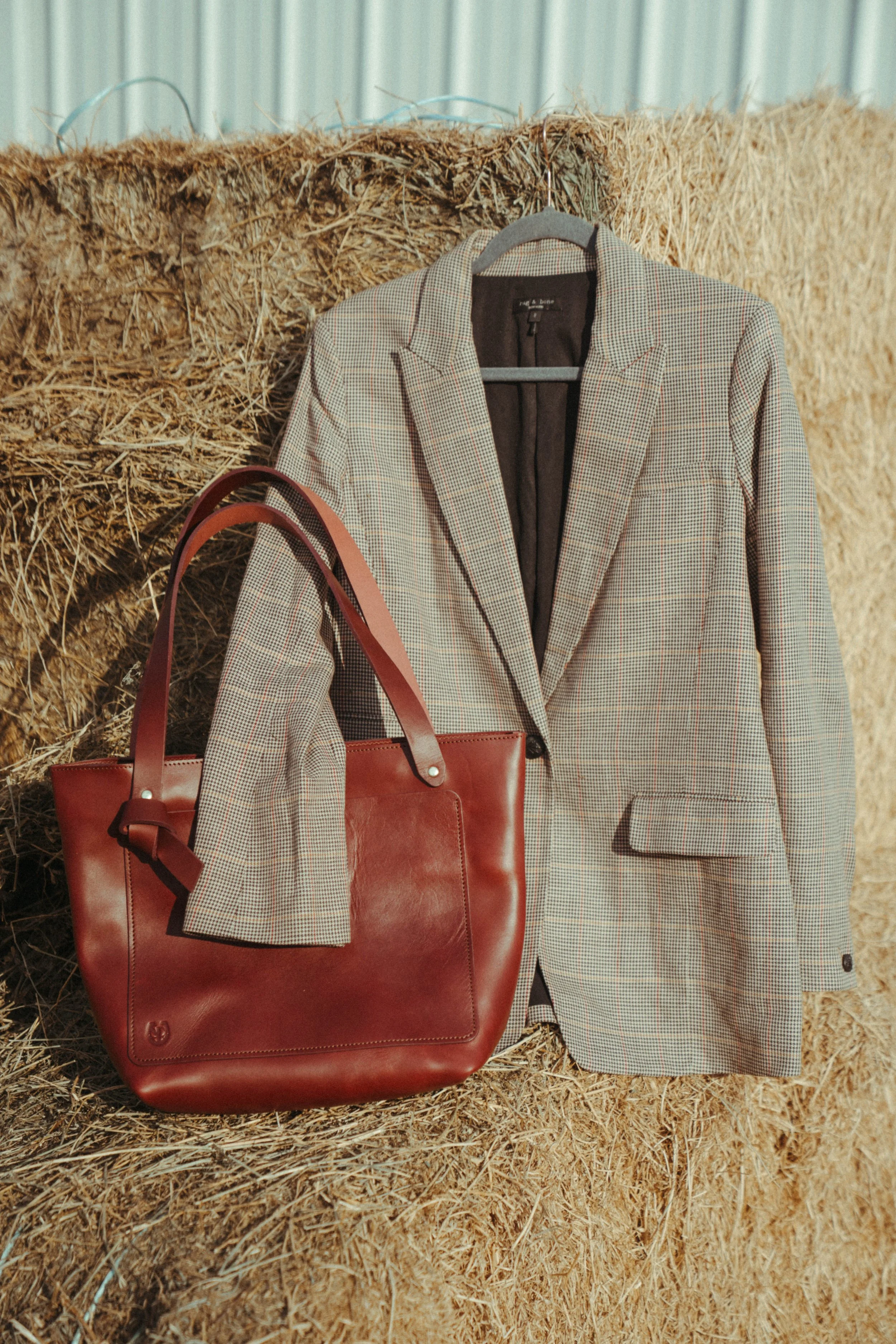 Equestrian product-style photographs featuring a tote bag and jacket in a beautiful outdoor setting, showcasing the product, equestrian lifestyle, and connection with the  horse life through natural, editorial-inspired imagery.