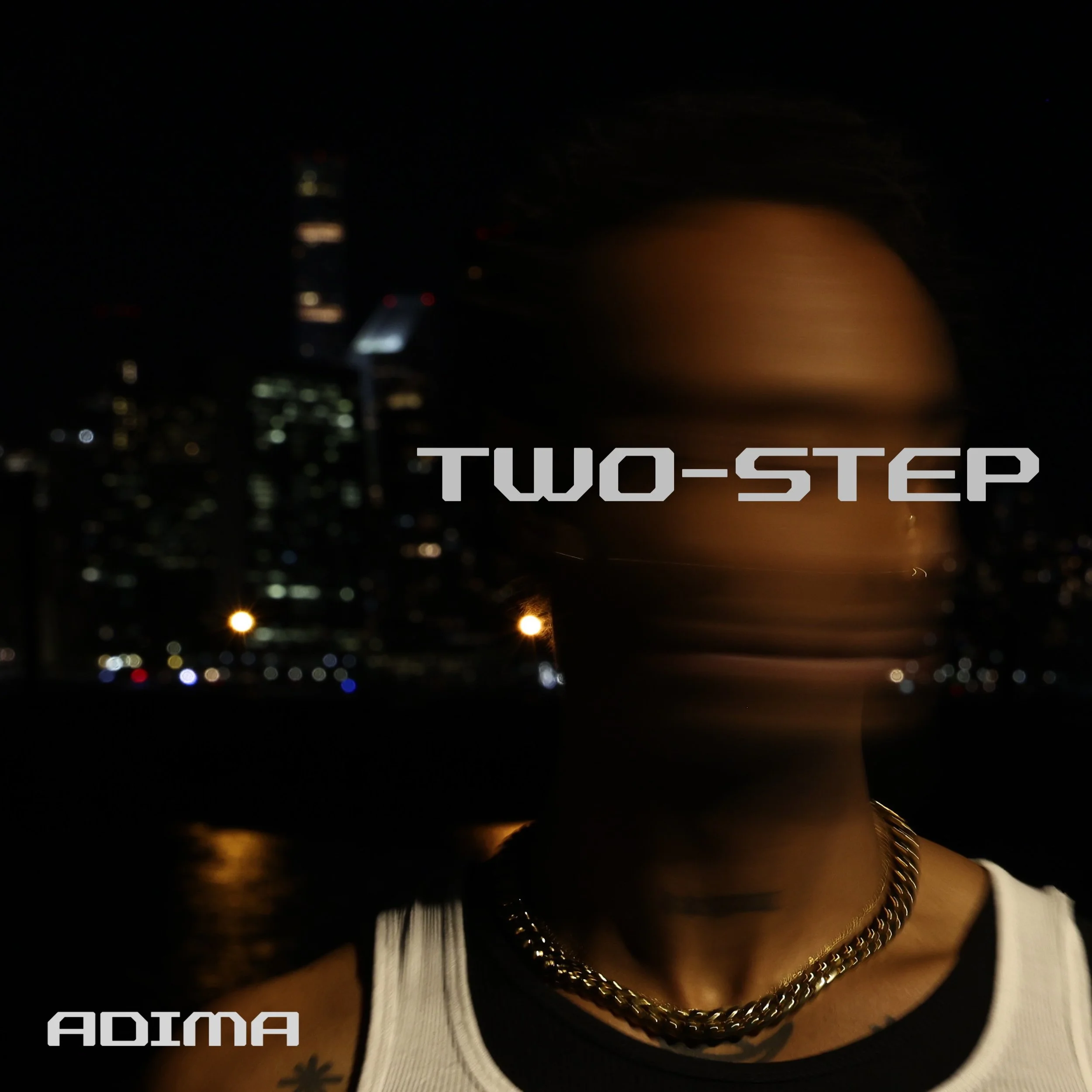 A person with a shaved head and tattoos, wearing a white tank top and gold chains, standing in front of a cityscape at night. The photo has the text "TWO-STEP" in large letters across the face and "ADIMA" in smaller letters at the bottom.