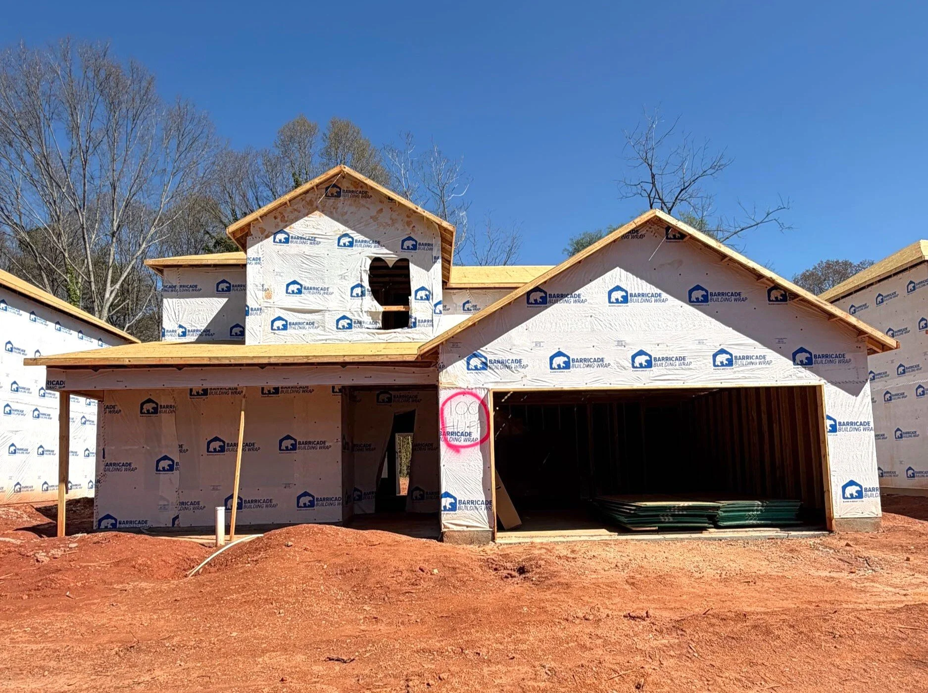 Black and white architectural drawing of a two-story house with a front door, six windows, and an attached garage.