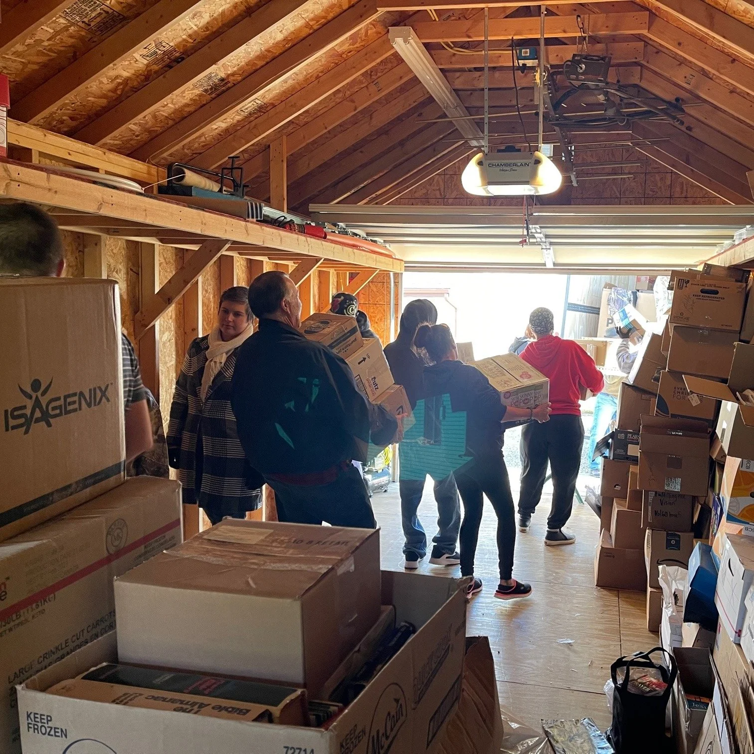 A group of volunteers helps to load Bibles onto a truck for donations.
