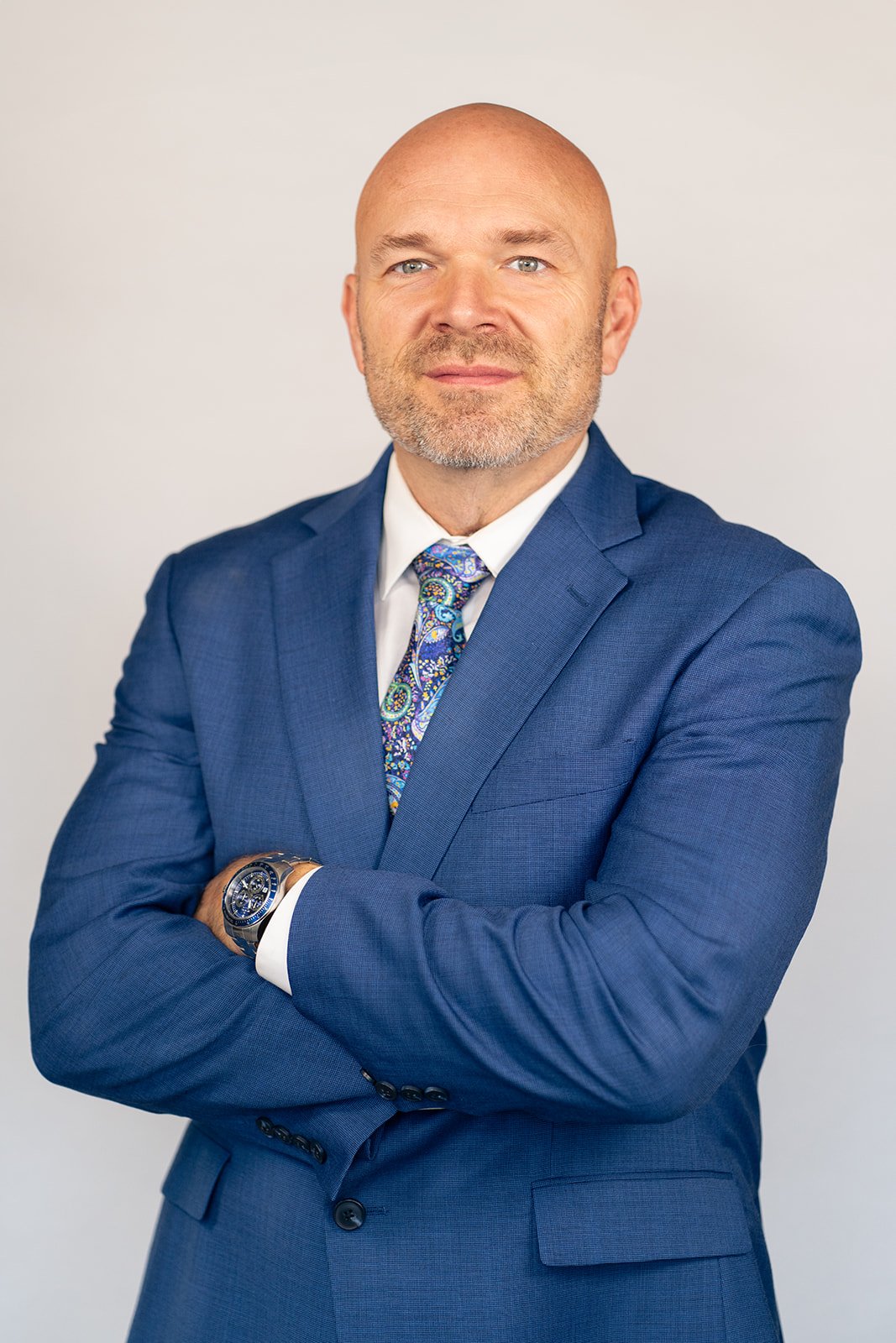 powerful position headshot photo of a man with his arms crossed