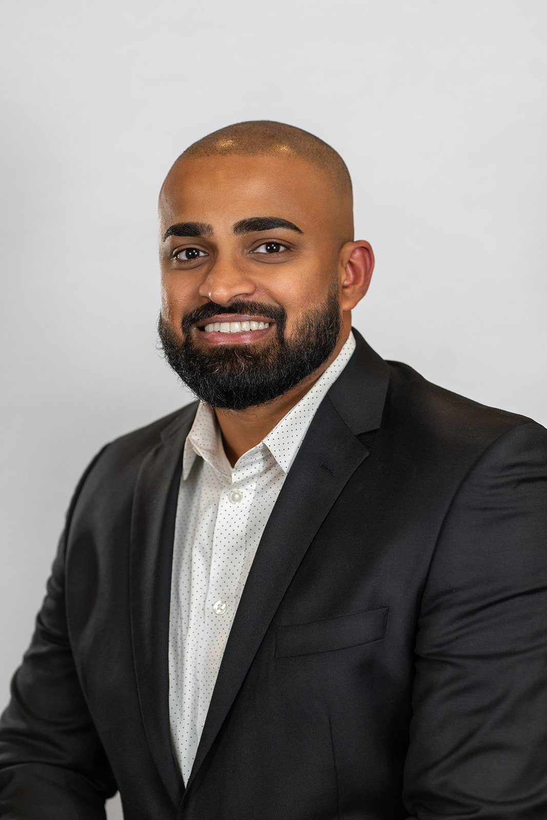 Professional Realtor headshot in front of a light grey background