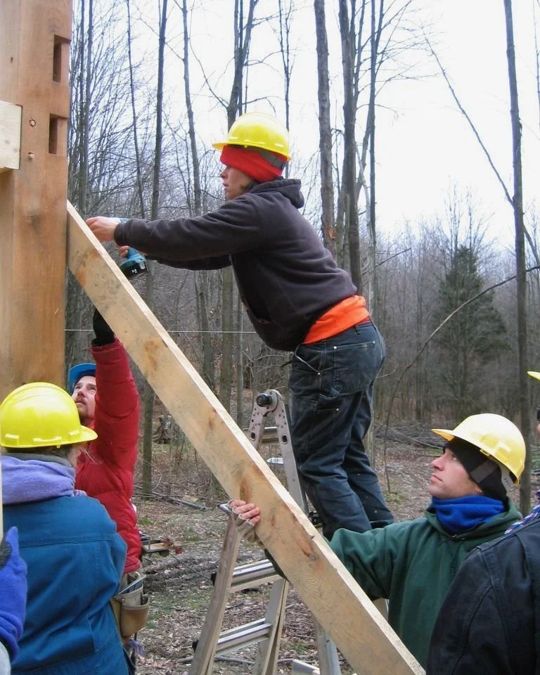 "I was 7 months pregnant with Calea during the raising of my timber frame house in 2006. I cut the frame myself while I was pregnant. It was the first frame I ever cut. 

Scott milled all the timbers from trees on our property. Aaron Dennis from