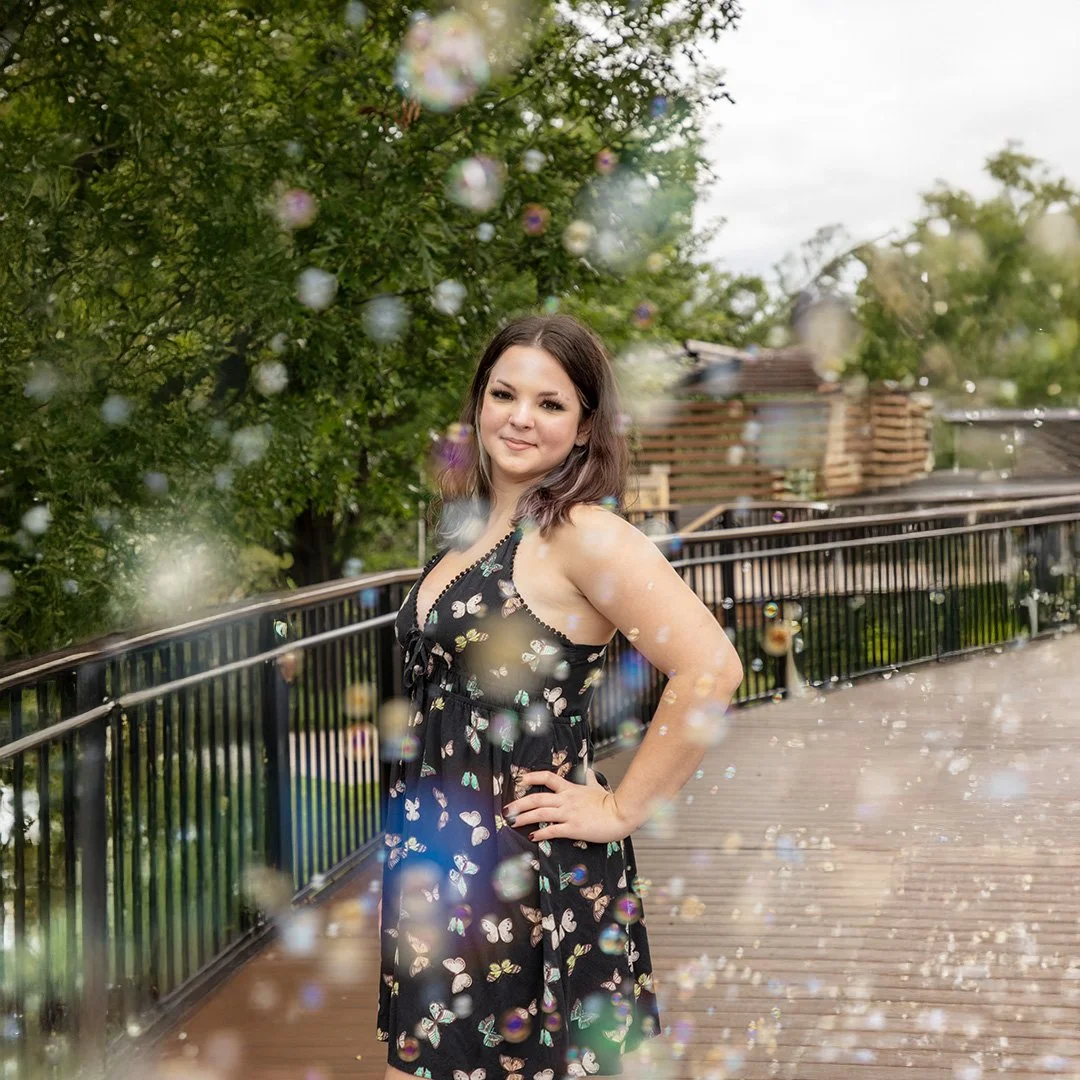 Senior in the park with bubbles, girl wearing a butterfly dress