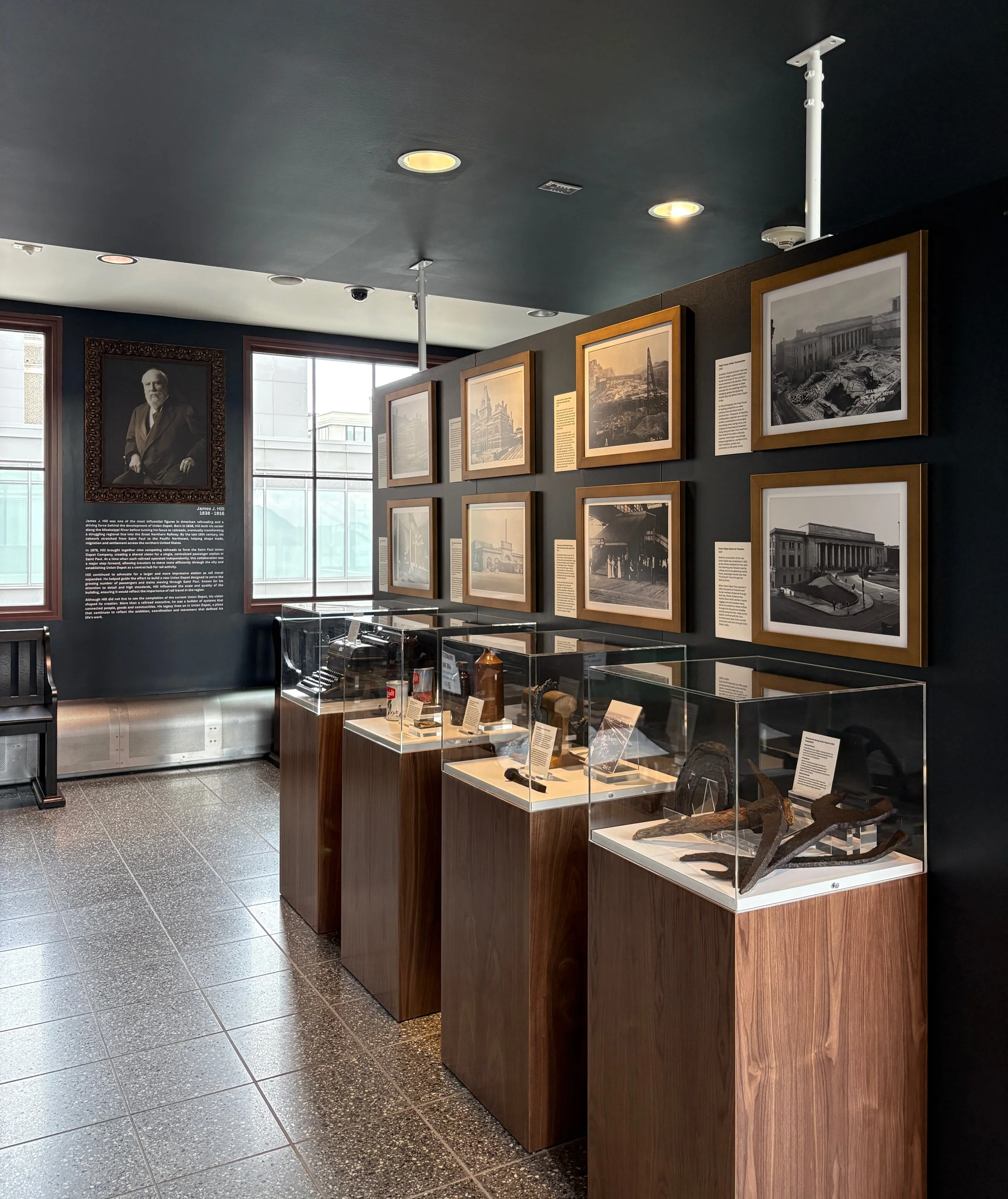 Historic railroad artifacts, framed archival photographs and custom museum display cases in the renovated Historic Stair Museum at Union Depot in St. Paul, Minnesota, curated by West Design.
