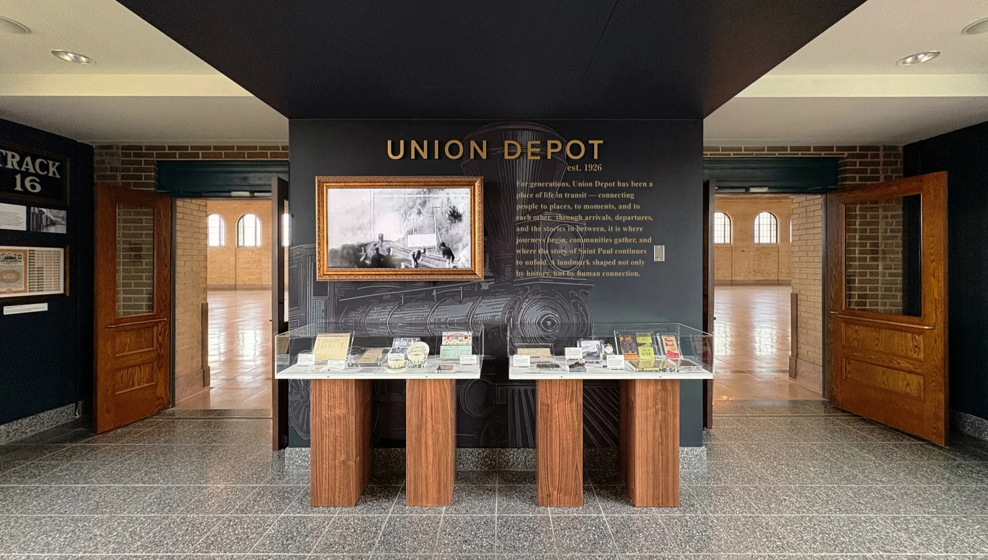 Historic Stair Museum exhibit update at Union Depot in St. Paul, Minnesota, featuring curated railroad artifacts, custom display cases, historic imagery and dimensional gold signage by West Design.