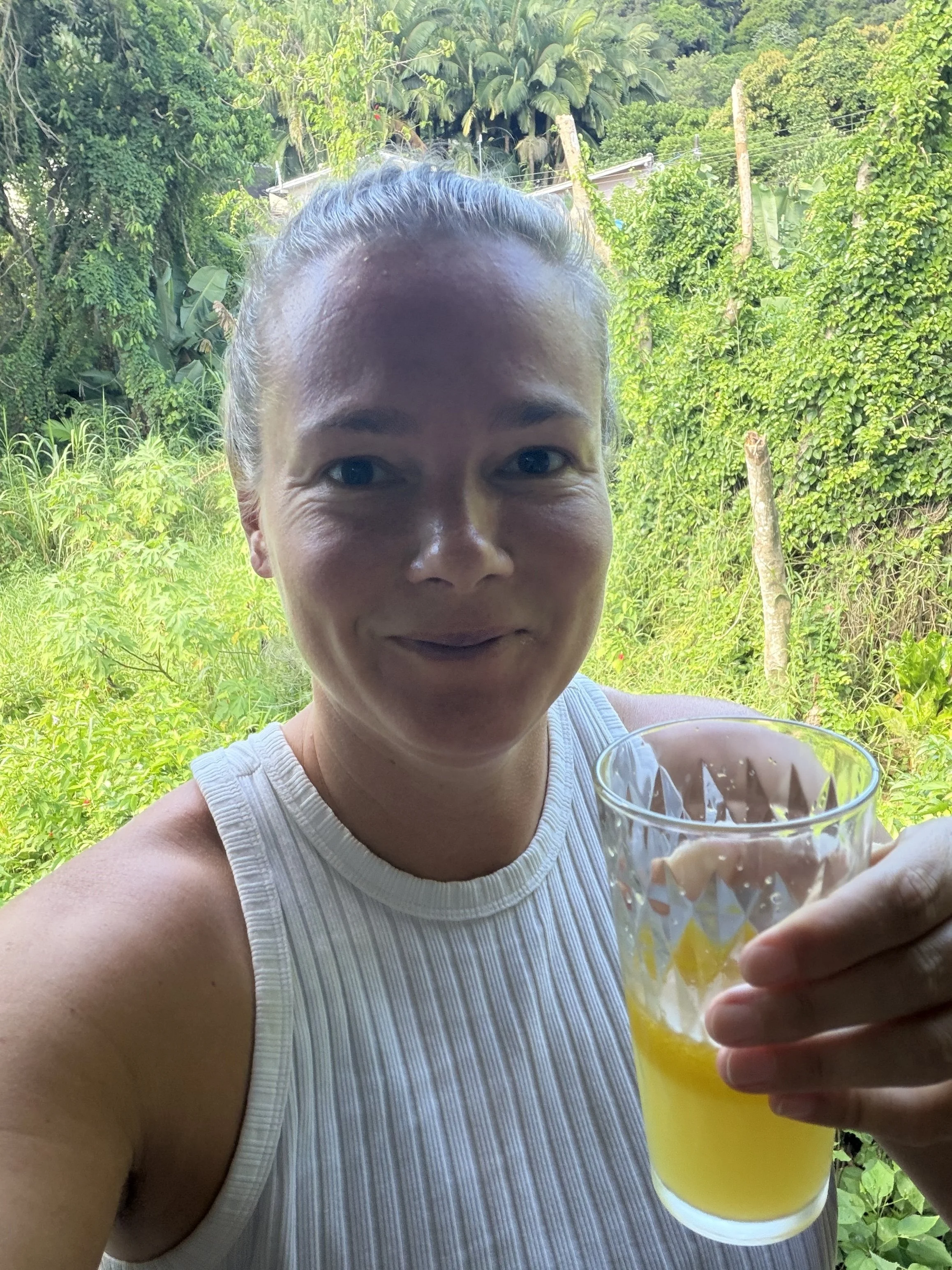 Nik Drinking Her Morning Liver Shot With Olive Oil and Citrus with the Jungle in the Background