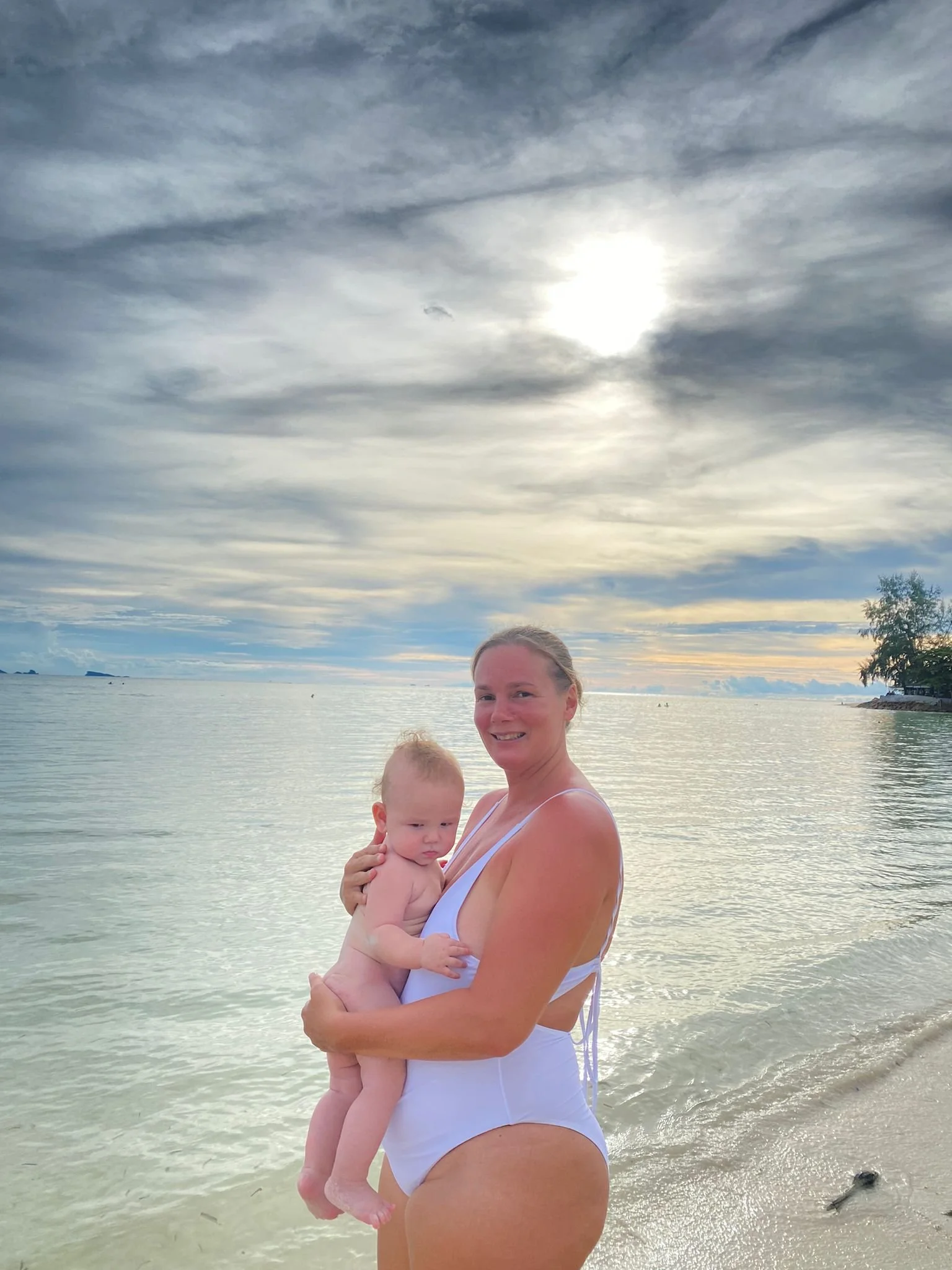 Nik Heartsong on Beach in Thailand 50 pounds heavier after second birth root cause healing with Winged Heart Healing