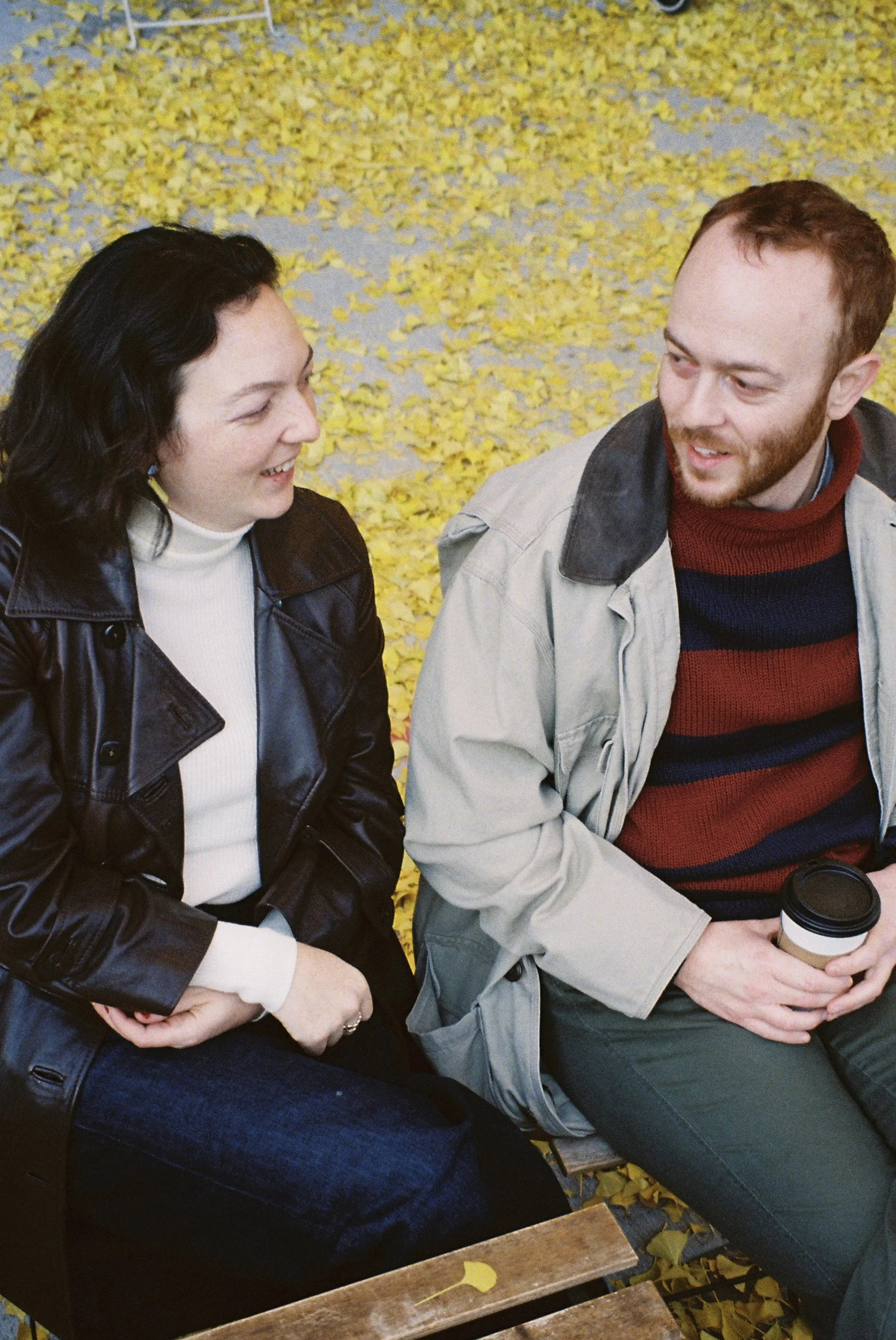 Laurie’s customers, Mariana and Carmen holding hands on a green lawn on their wedding day.