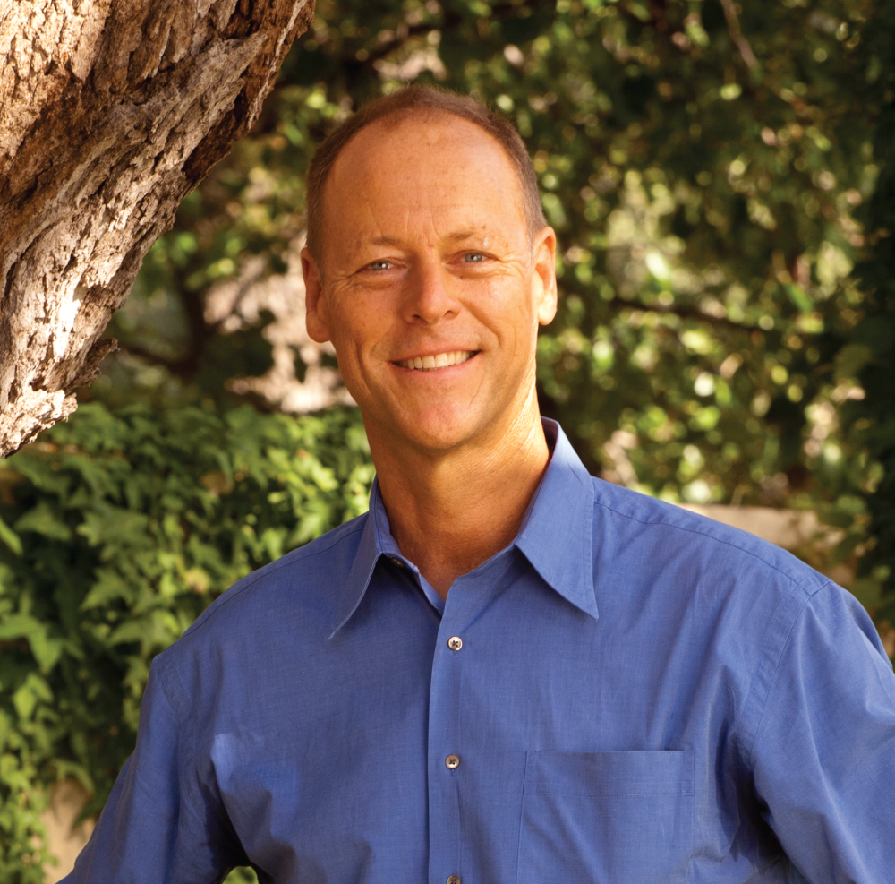Headshot of Walter Robb standing wearing a blue button down.