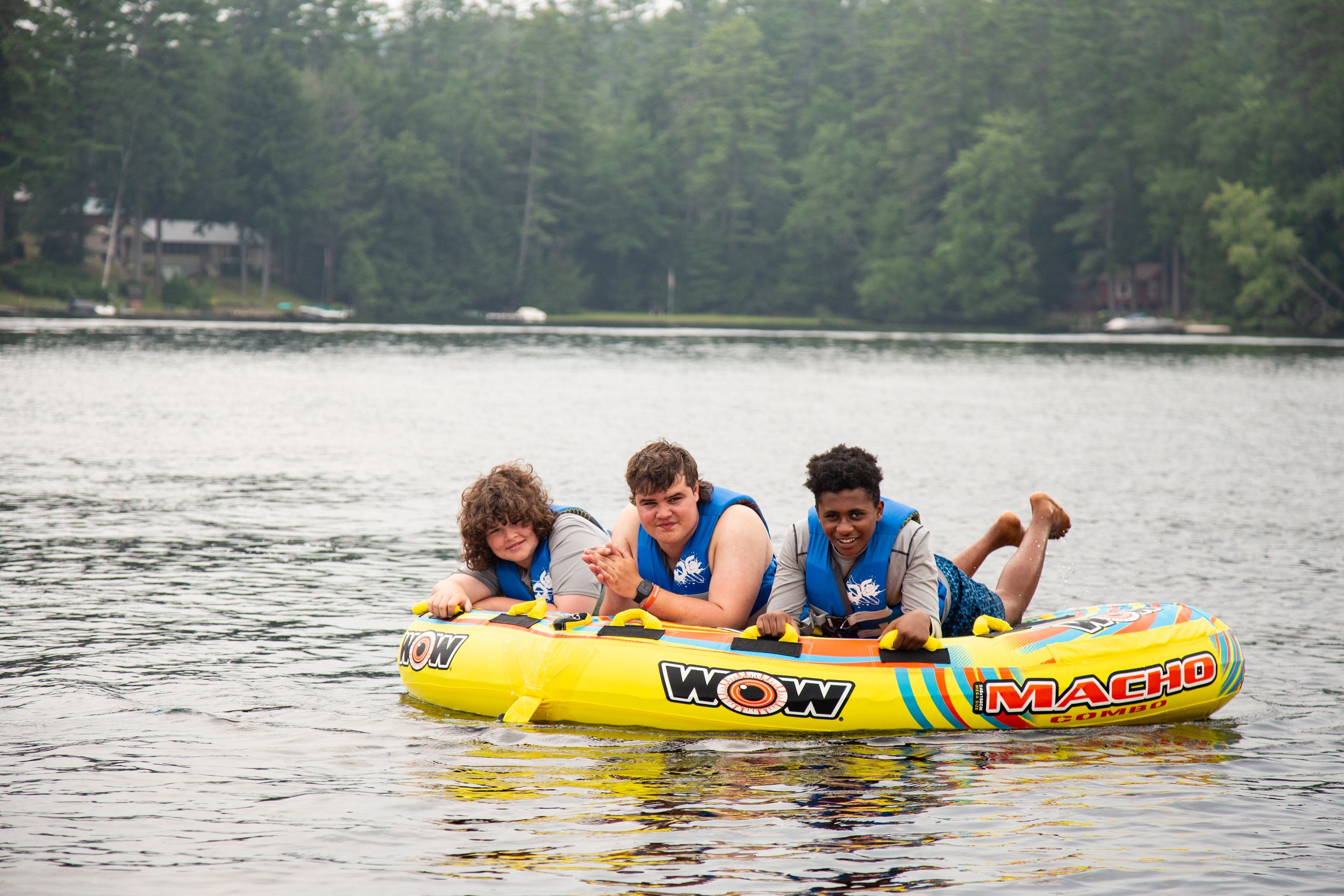 Kids water tubing with counselor at sleepaway camp in the Adirondacks.