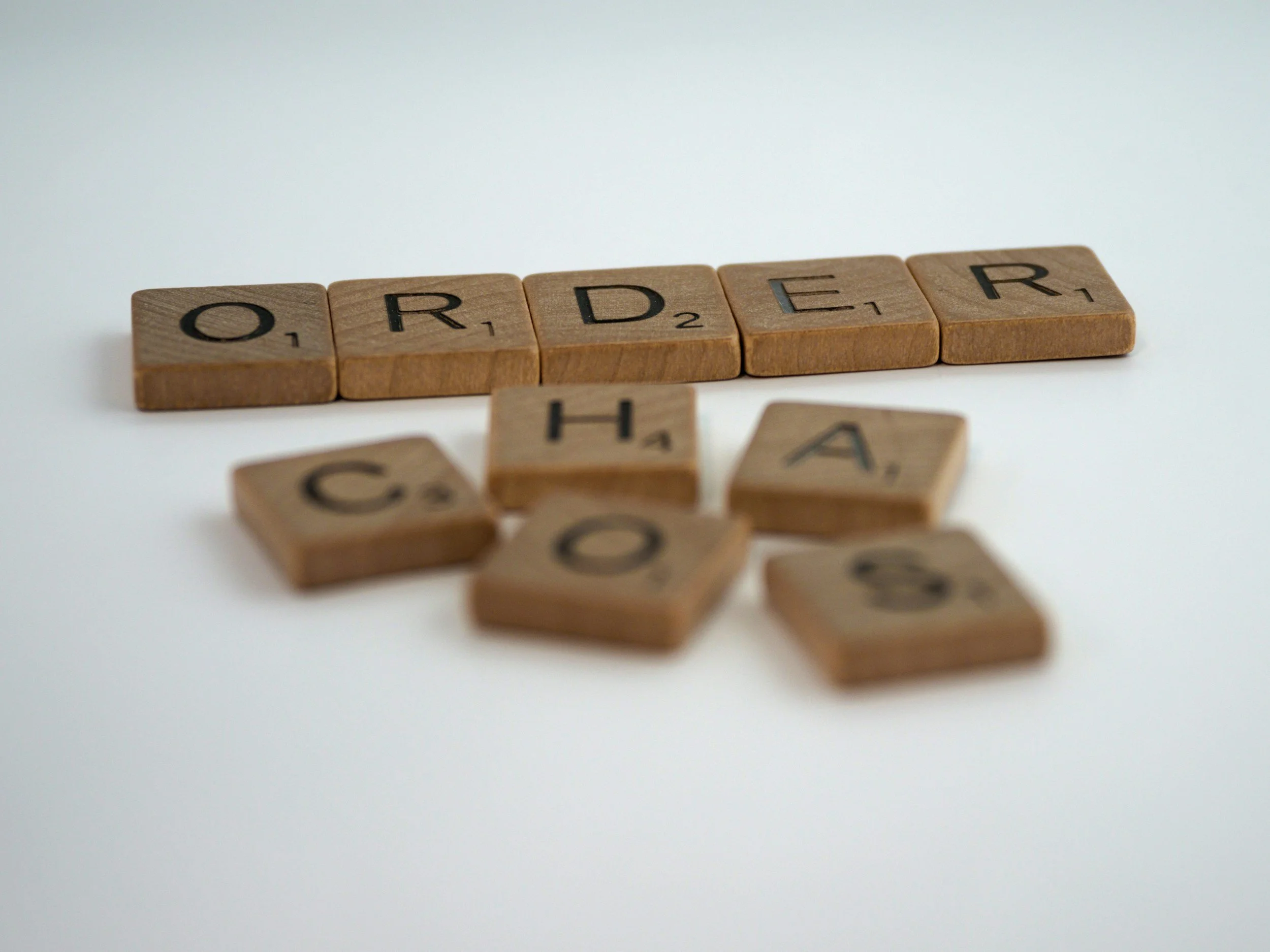 Letter blocks spelling order and chaos to represent creating organizing systems that work