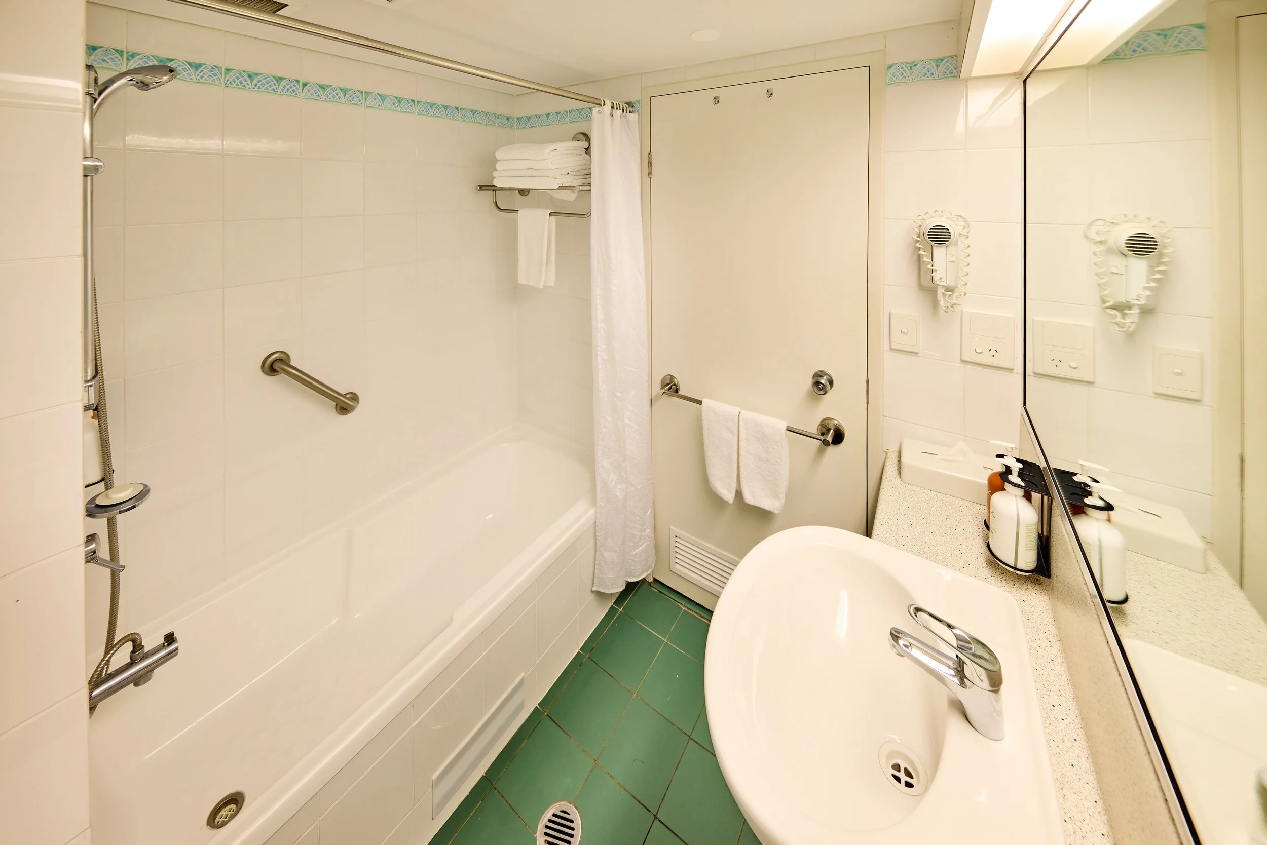 Bathroom with shower over bath tub, sink & vanity.jpg