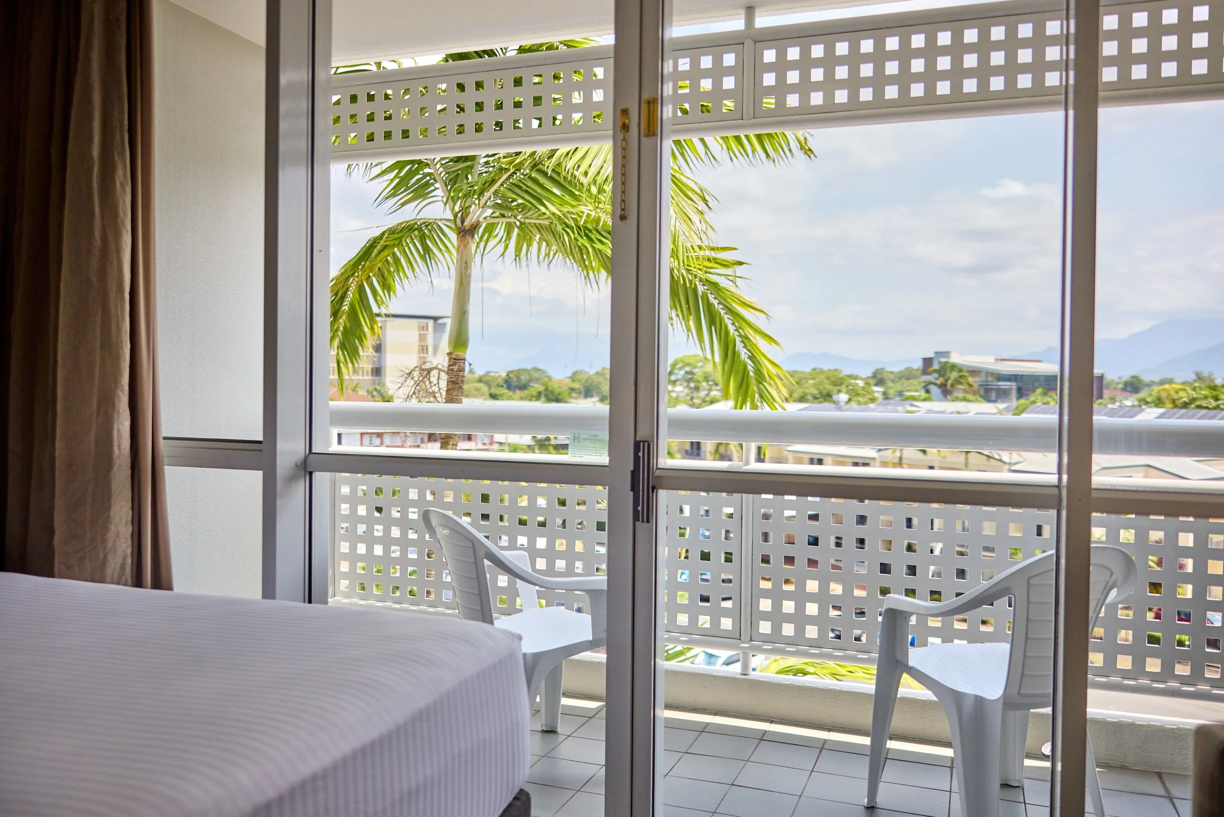 Private balcony with 2 chairs over looking the city skyline.jpg