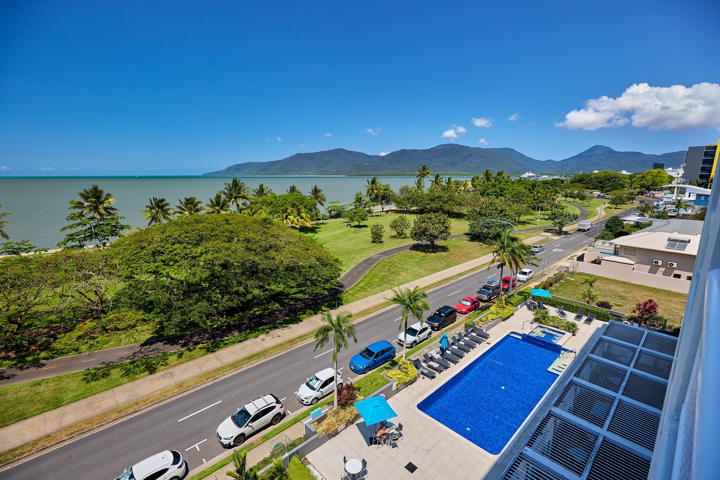 View from a balcony overlooking the hotel pool and the ocean.jpg