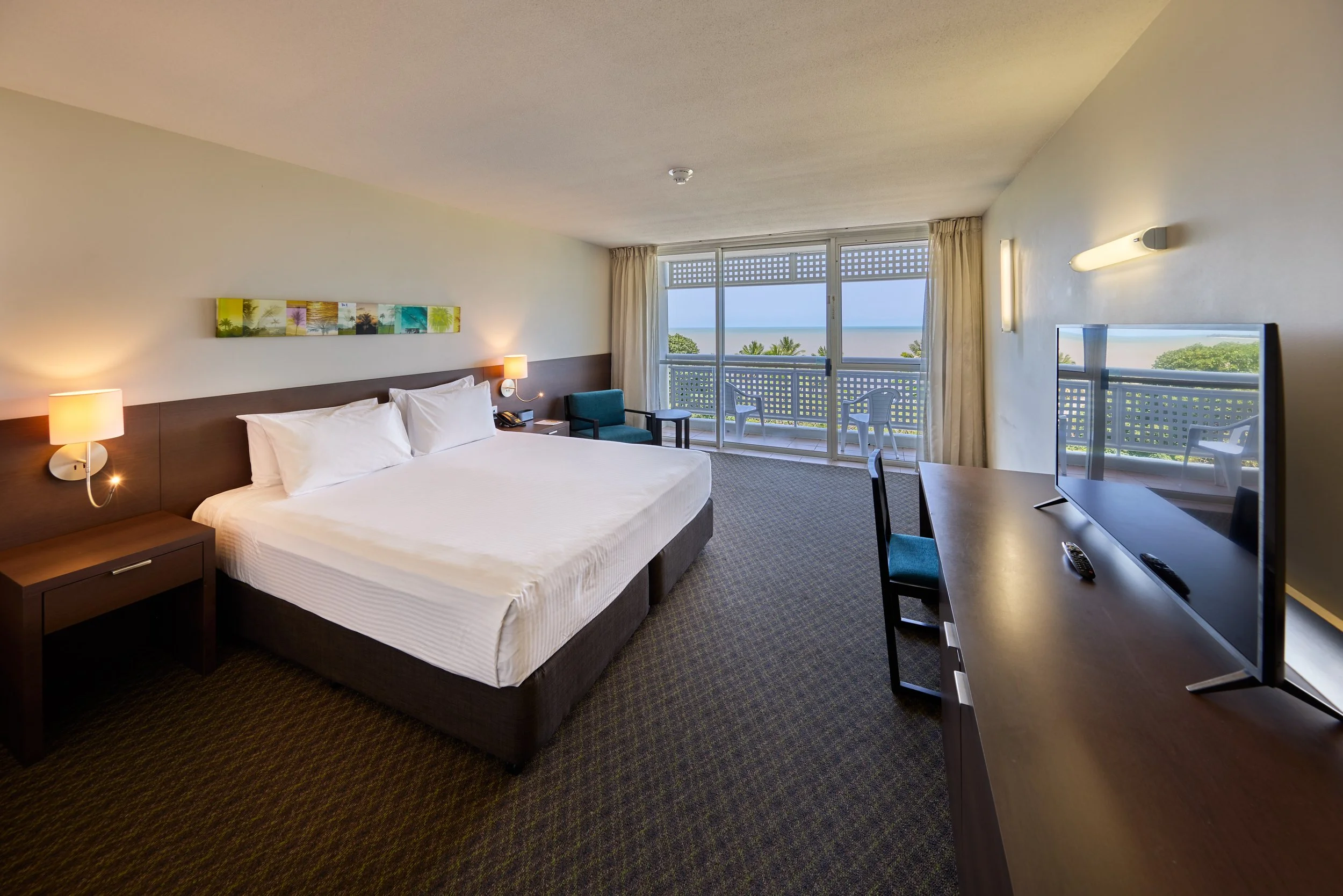 King Bed with white linen overlooking a balcony and the sea.jpg