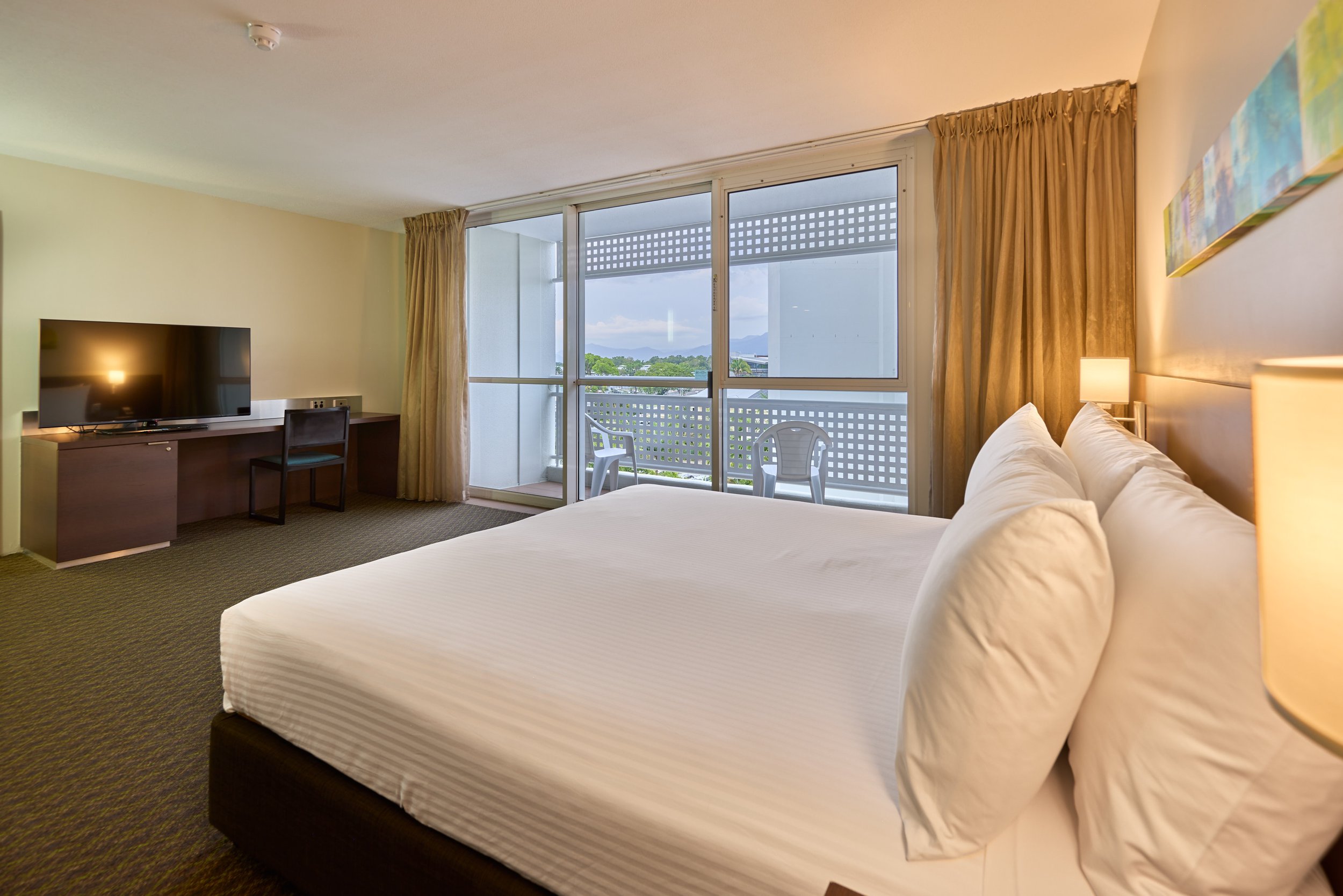 King bed overlooking balcony and across to smart tv.jpg