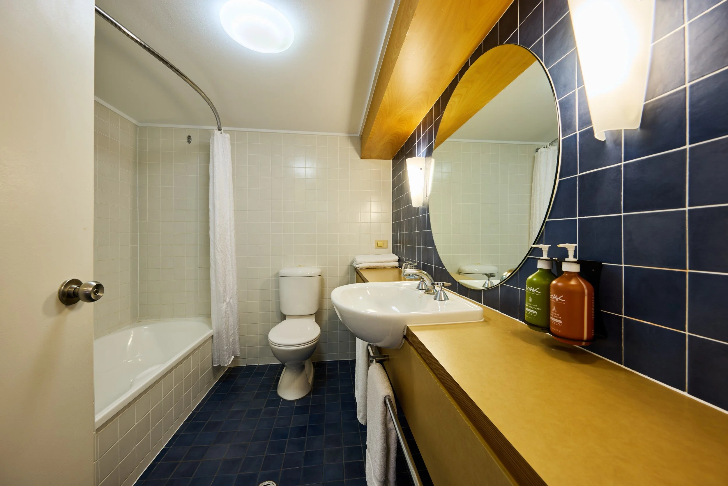 Bathroom with sink, vanity, shower over the bath tub and toilet - Copy.jpg