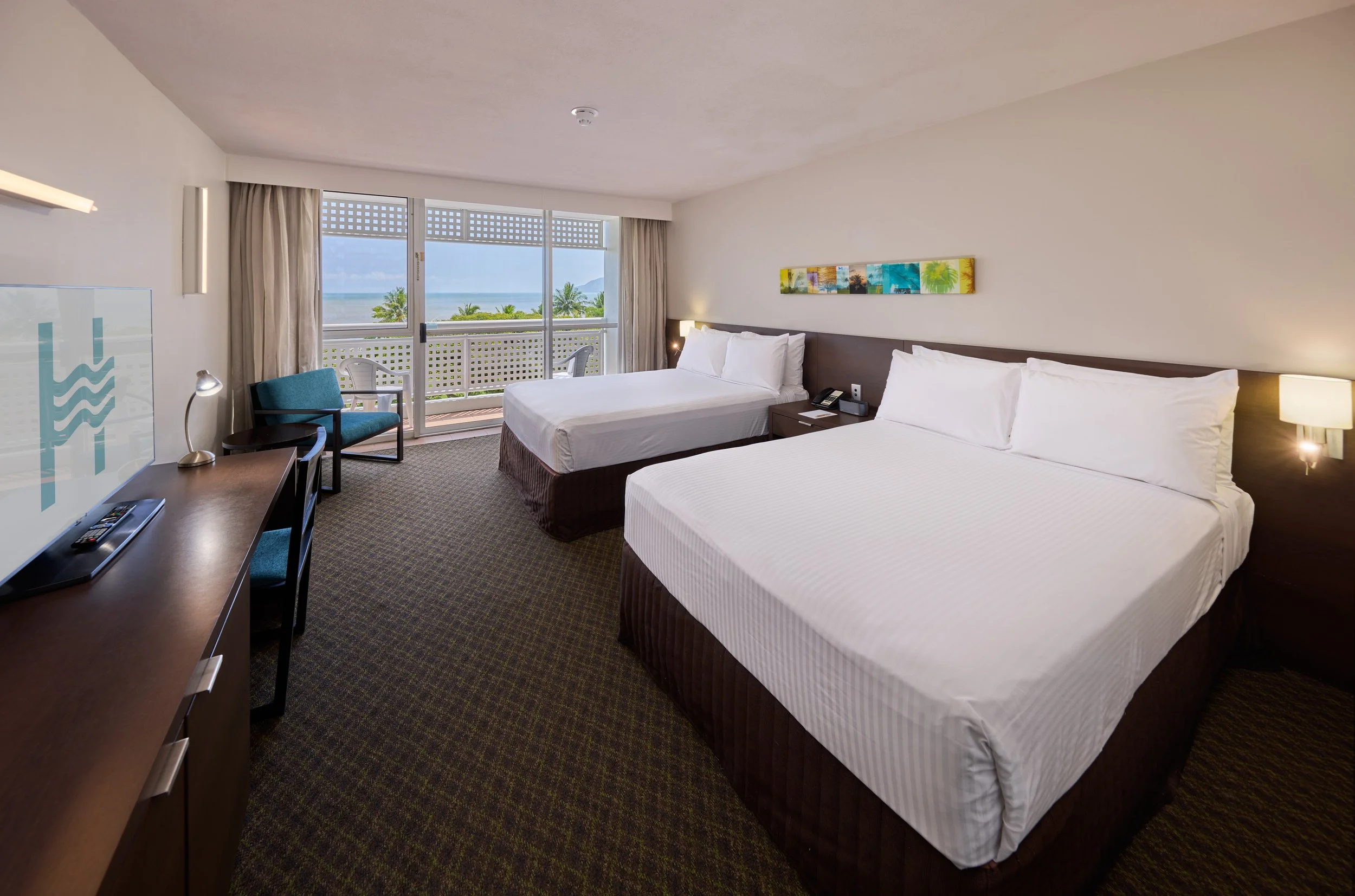 Two double with white linen overllooking a private balcony with sea views (1).jpg