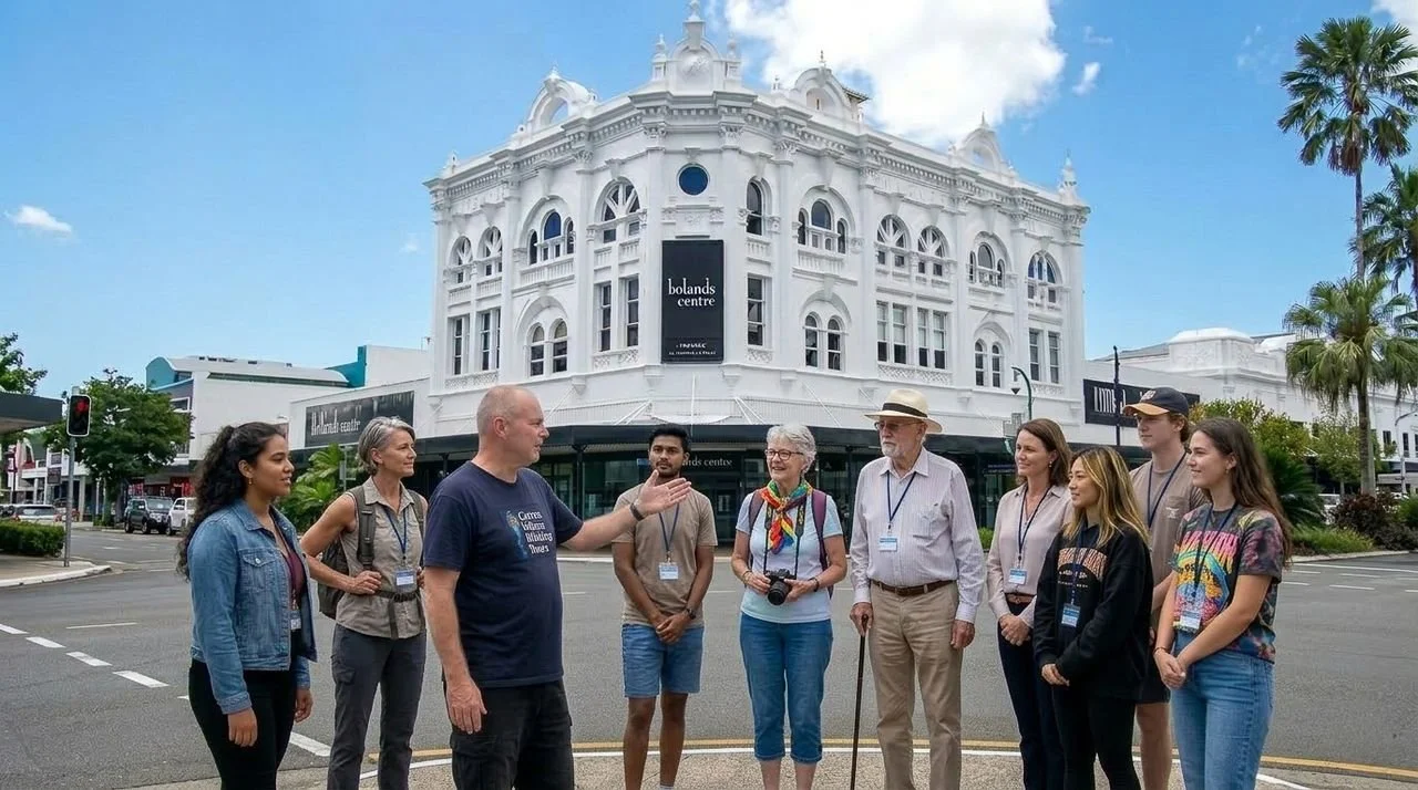 Group of tour participants led by tour guide in standing on the street during a Cairns Urban Walking Tour.