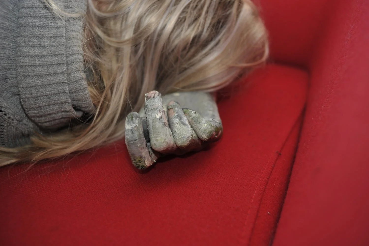 Marie Birkedal studio process, 2016, paint- and pigment-covered hand resting on a red chair in the artist’s Berlin studio.