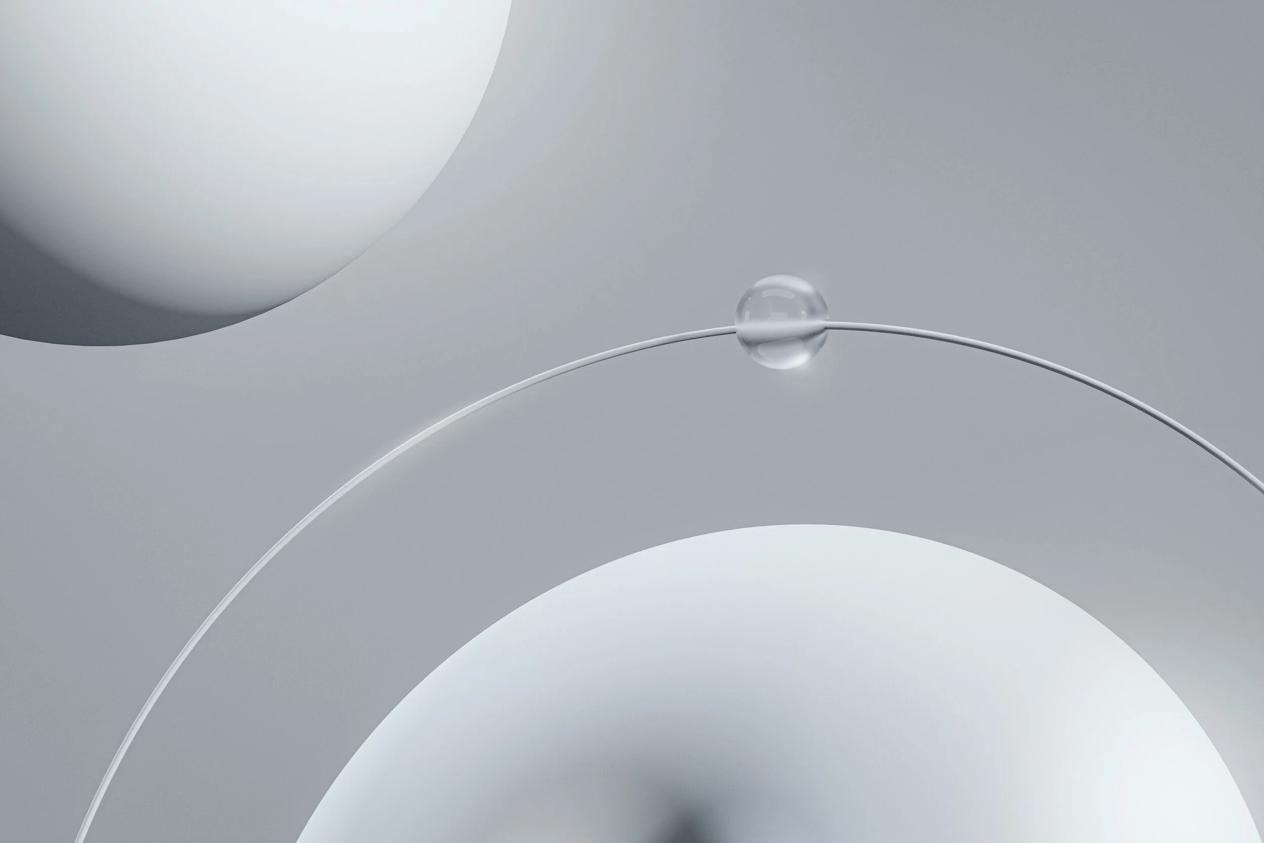 Close-up of abstract geometric shapes with spheres, circles, thin lines, and a transparent glass marble on a gray background.