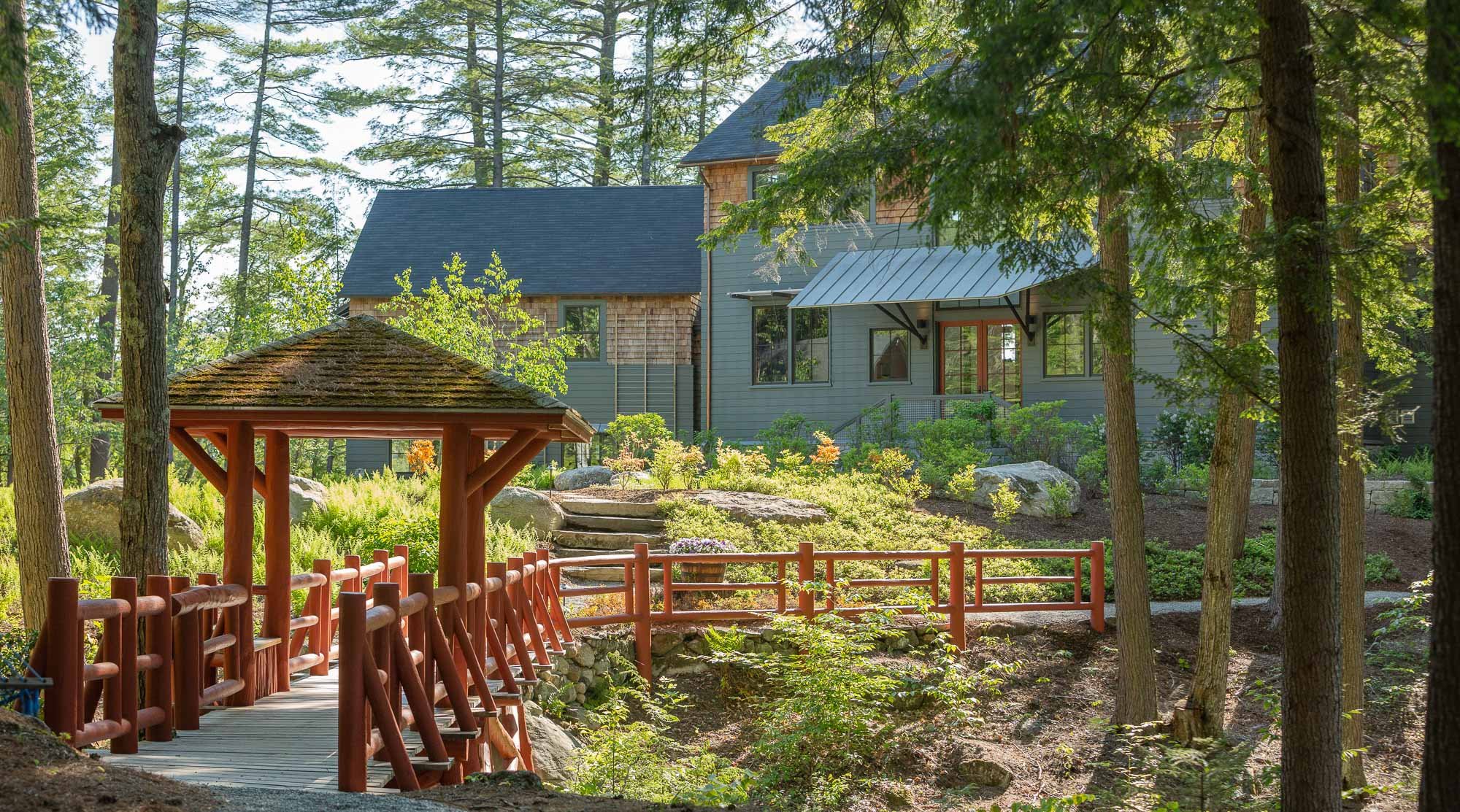 Red bridge outdoors a Lake Sunapee home-Kate Maloney Interior Design