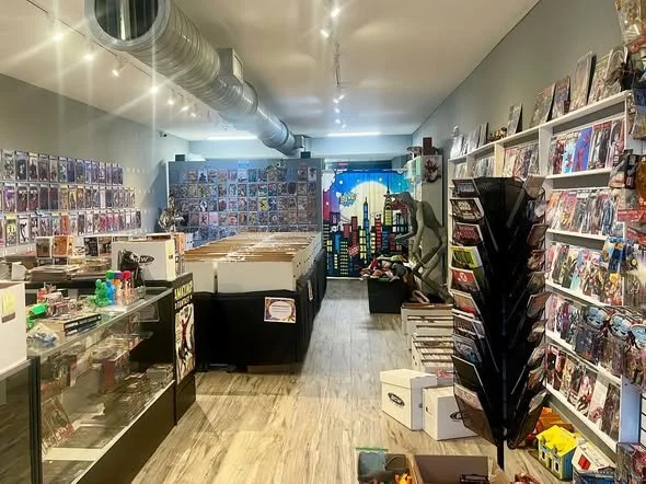 Interior of a comic book store with wall displays of comic books,  and various collectible items on shelves.