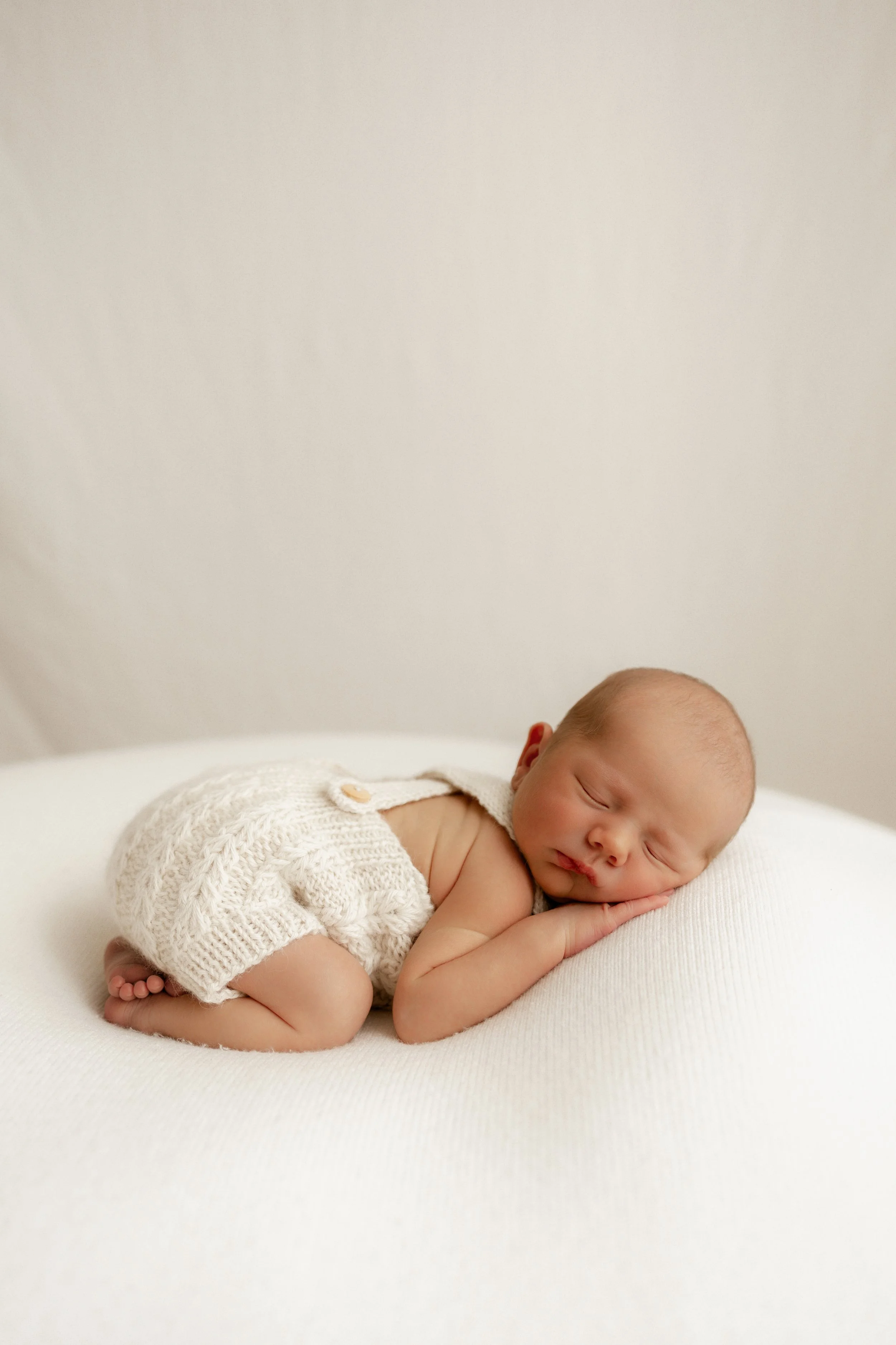 newborn baby perfectly posed of soft beanbag