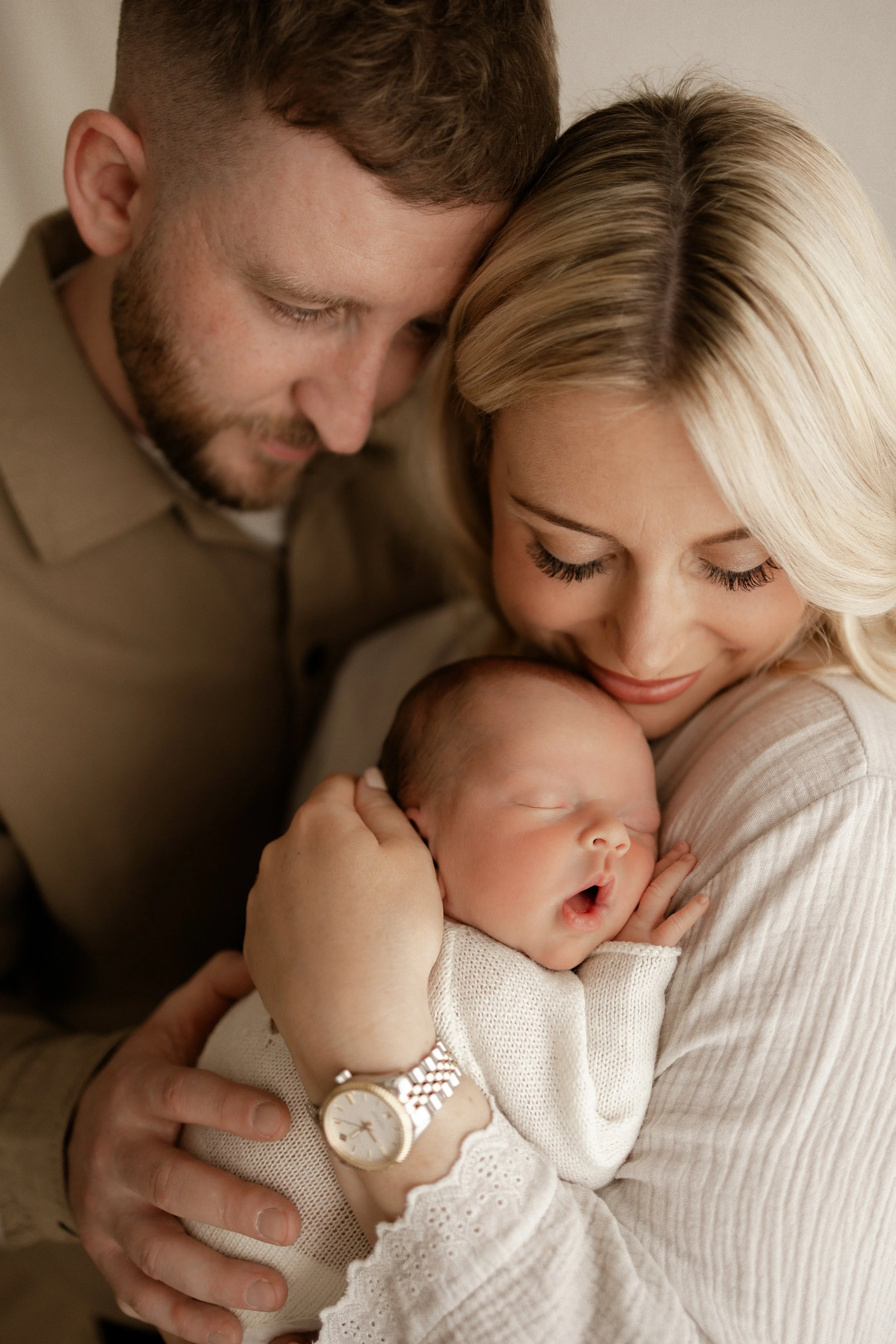 Mother, Father and baby snuggled together 