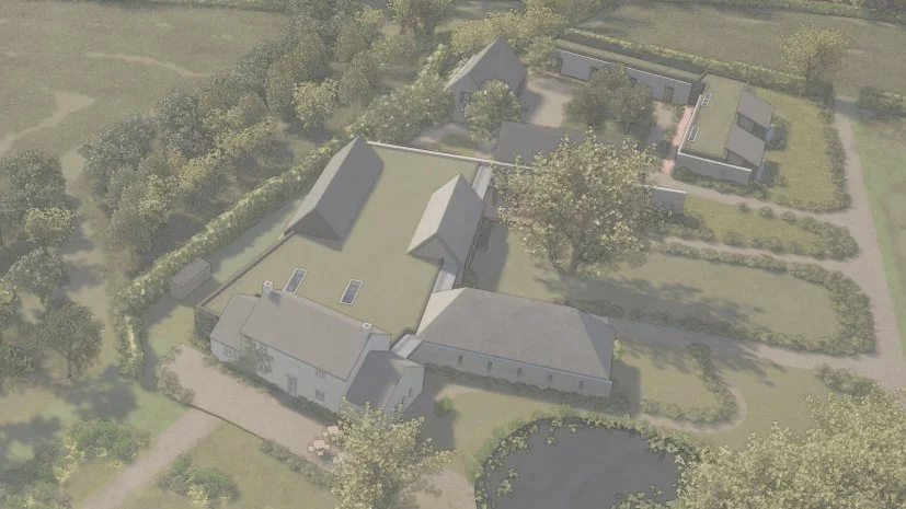 Aerial view of a large estate with a main house, surrounding outbuildings, trees, gardens, and a pond.