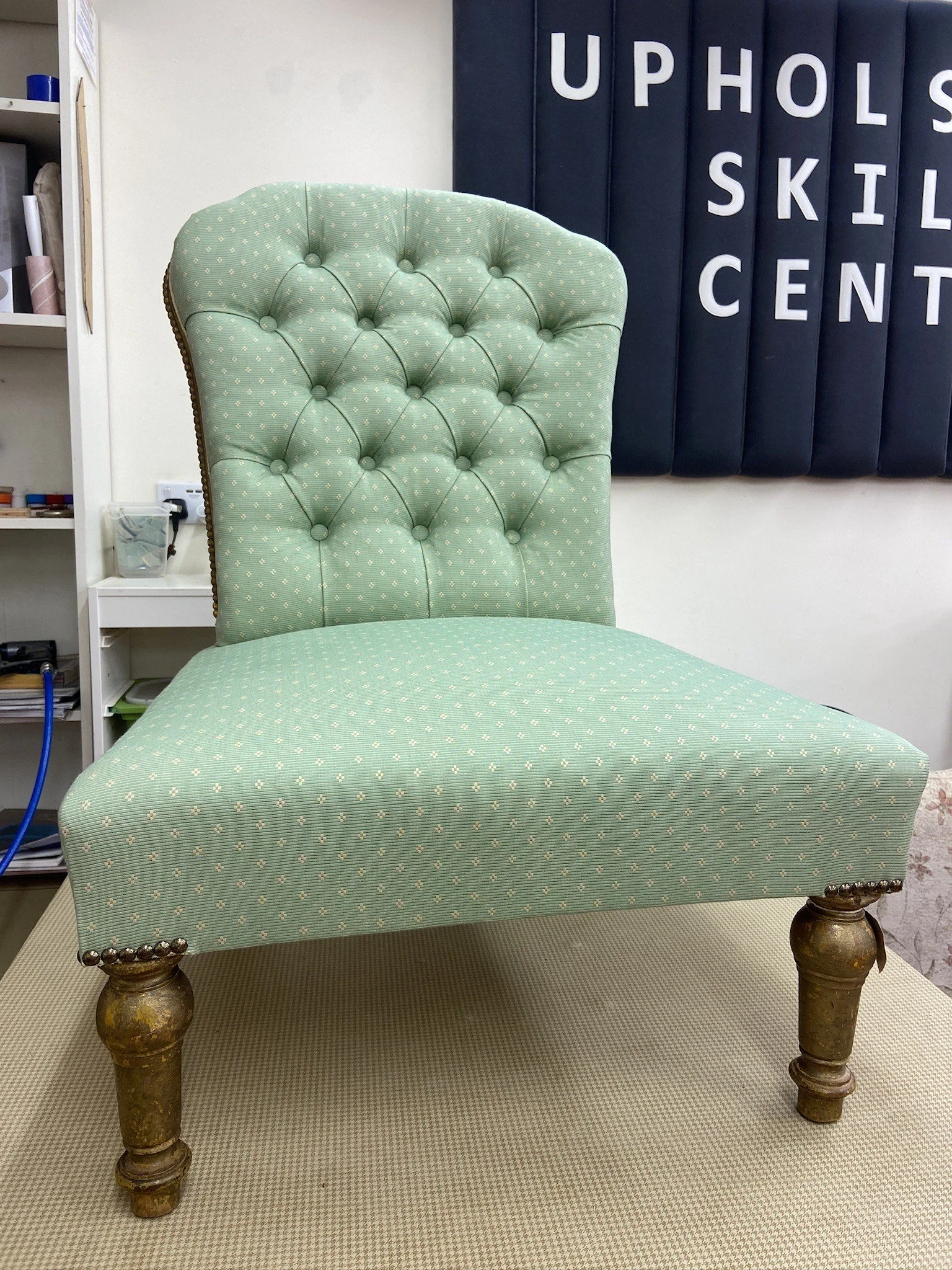 Traditionally upholstered nursing chair, covered with reclaimed fabric from Claridges Hotel 