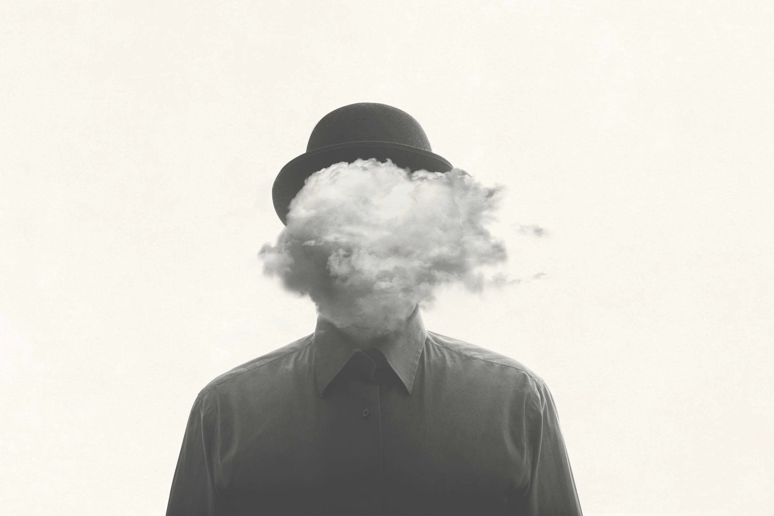 Image of a person with a black hat and a cloud in front of the face.