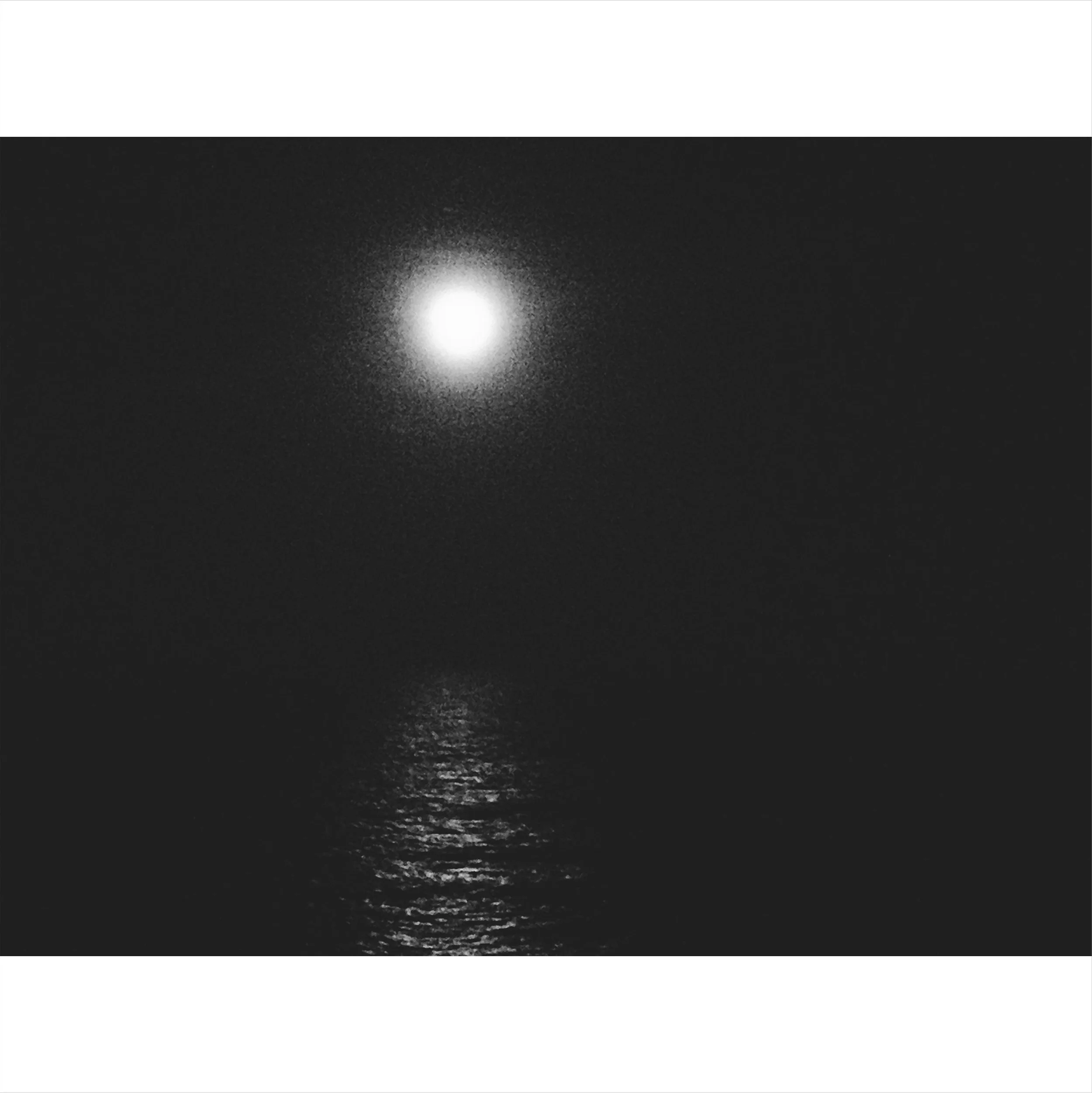 photo of a moon at night reflecting on water