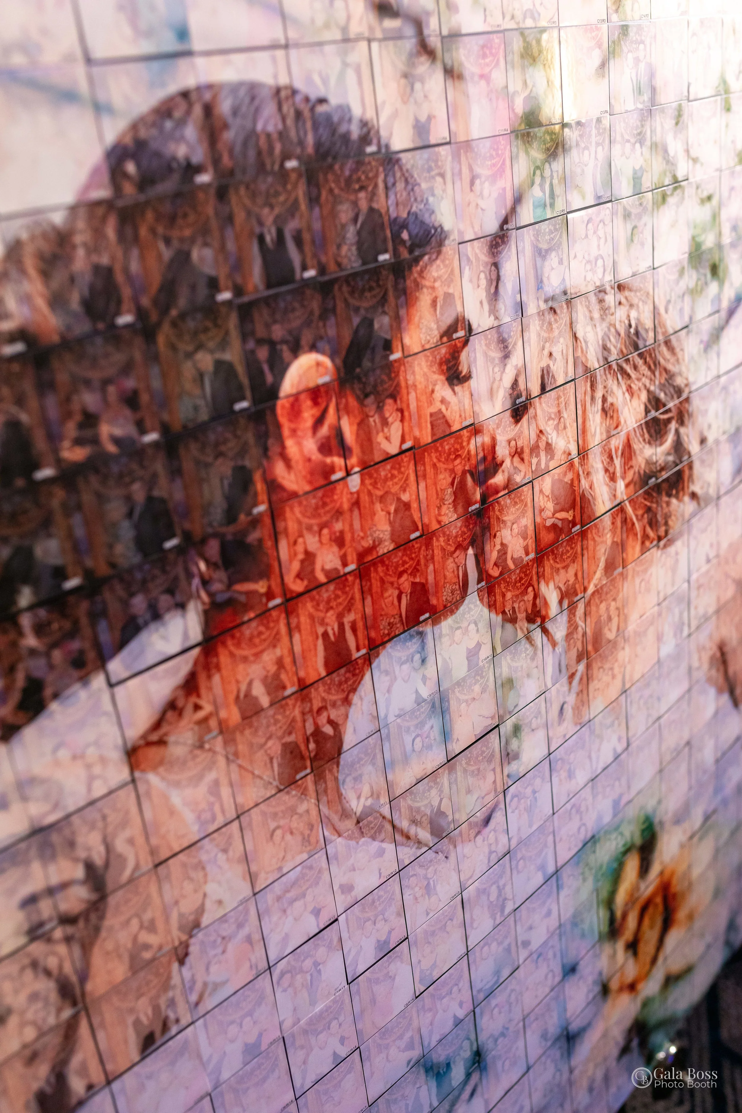 A photo mosaic featuring an image of two people kissing. The mosaic is made up of many smaller photographs, each contributing to the larger image. The scene conveys a romantic and artistic atmosphere.