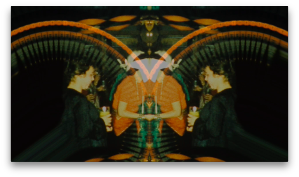 Mirror reflection of two women conversing in a festive setting with colorful lights.