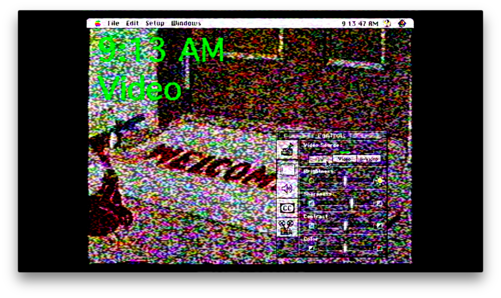 A computer screen with visible graphical user interface showing a Windows desktop, a video control panel, and a large green text indicating S 13 AM Video. The screen displays digital noise and color distortion.