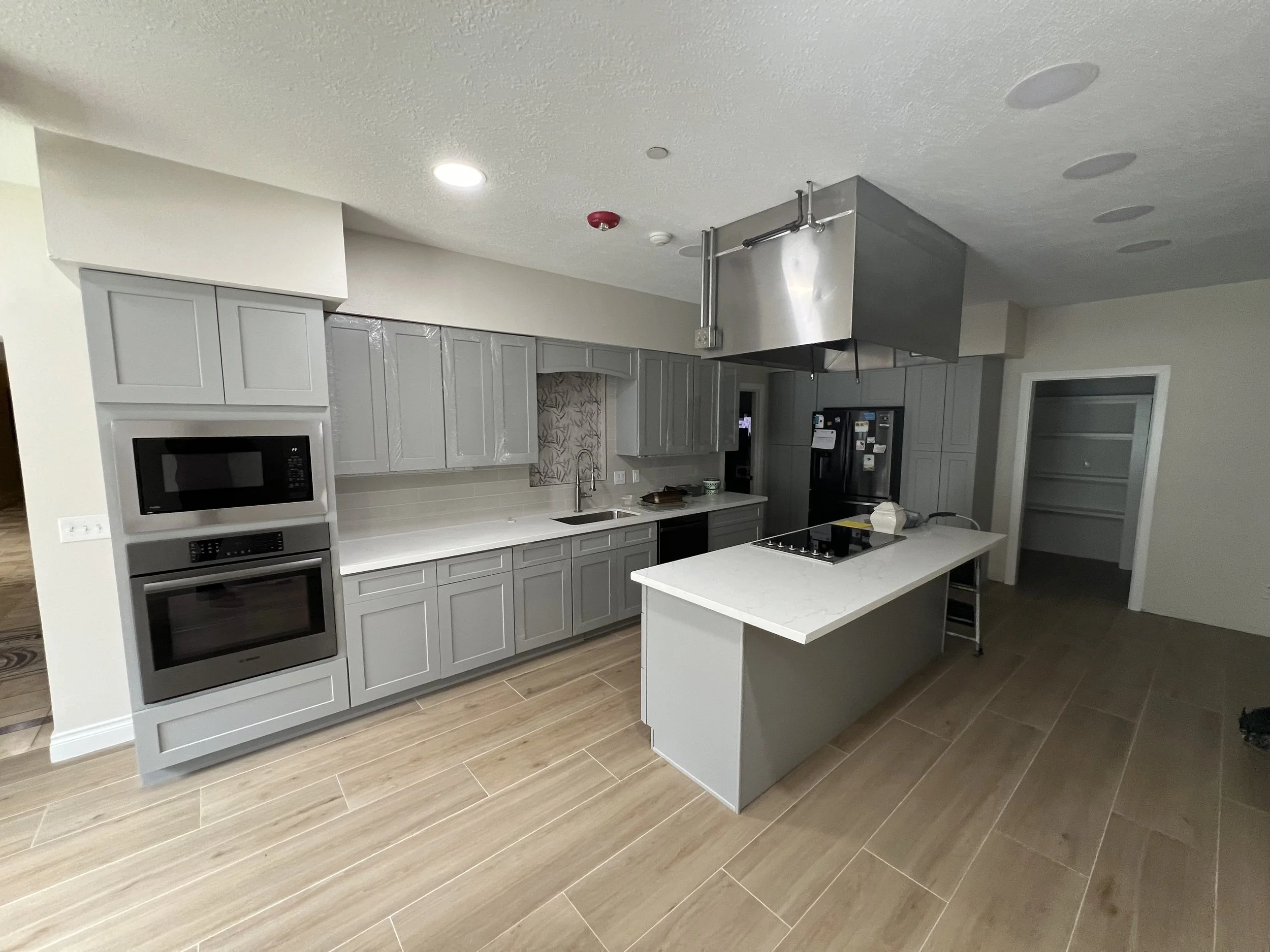 Modern Kitchen Remodel by Quality Cabinets Countertop Floors & More — Project 2 project photo