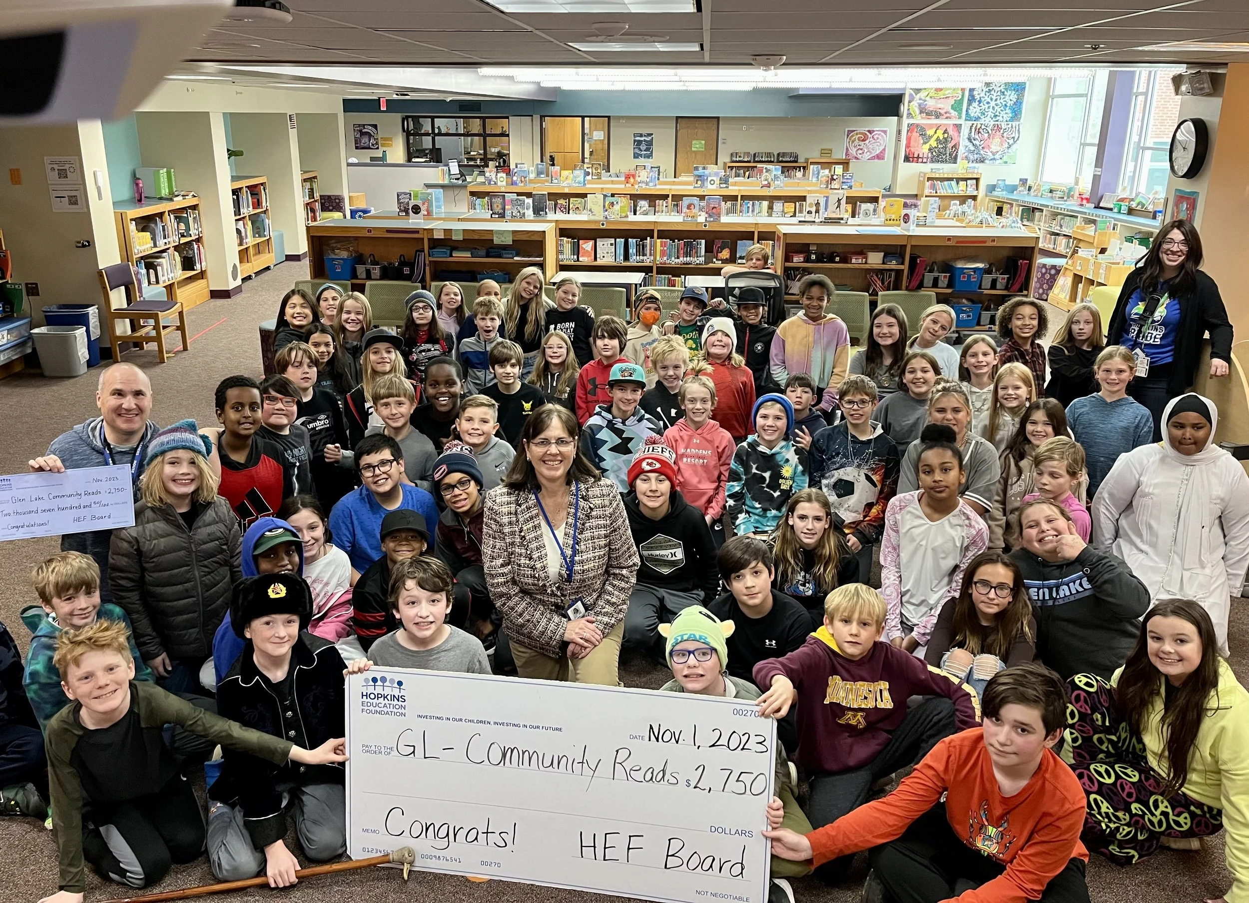 Group of students and adults with large grant check