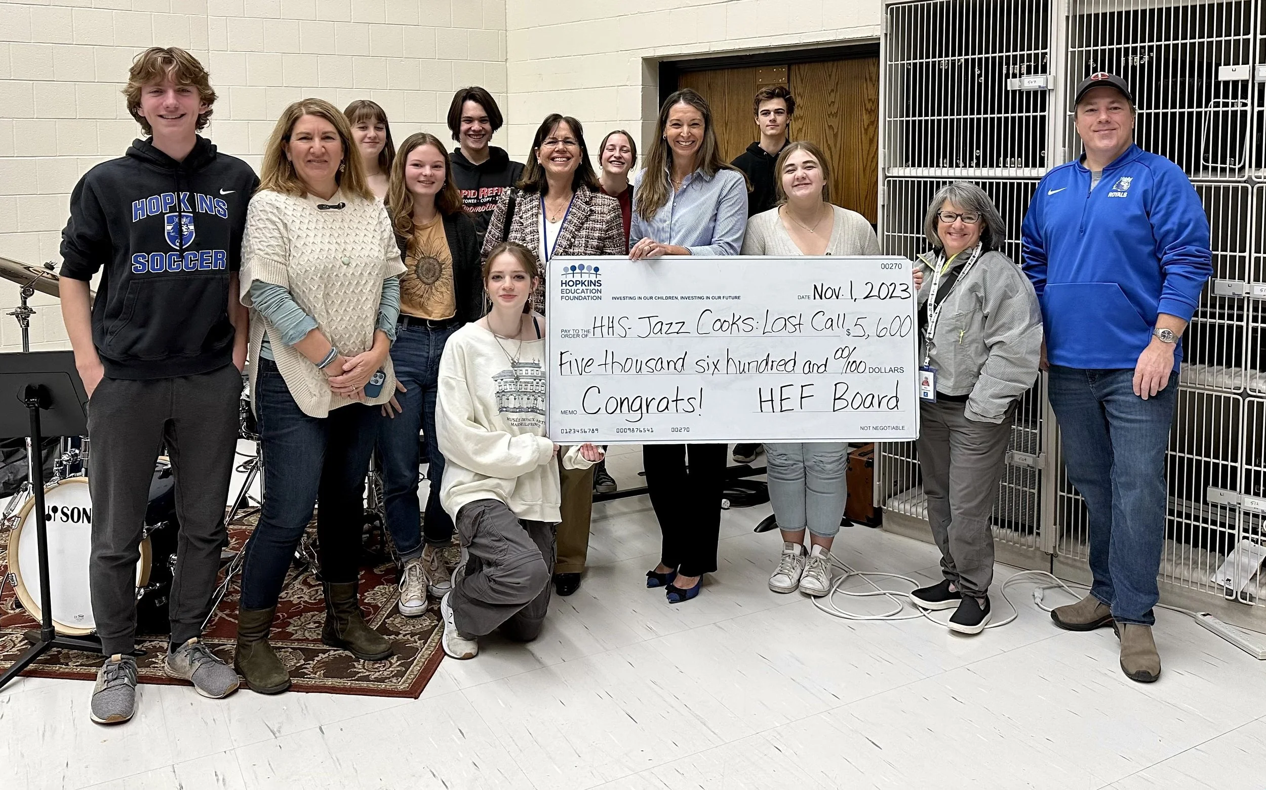 Group of students and adults with large grant check