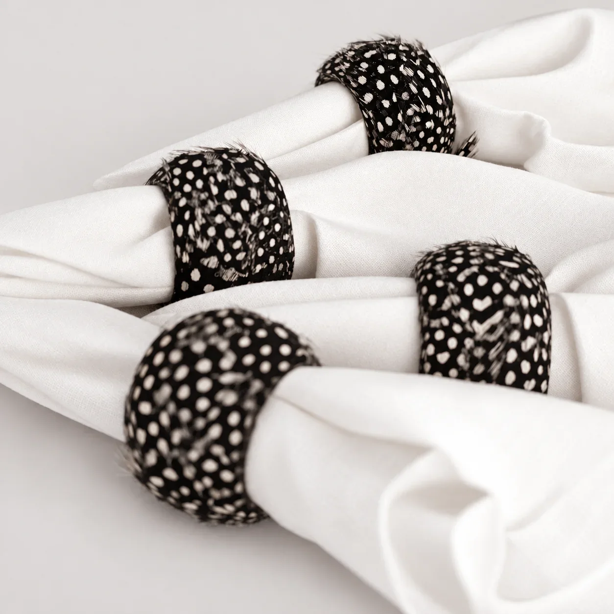 spotted-guinea-fowl-feathered-napkin-rings-product-shot (1).webp