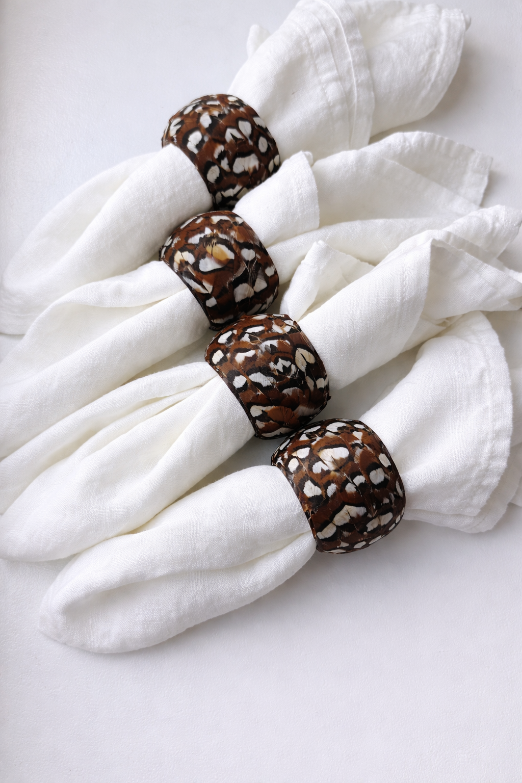 Feather-accented napkin rings close-up.png