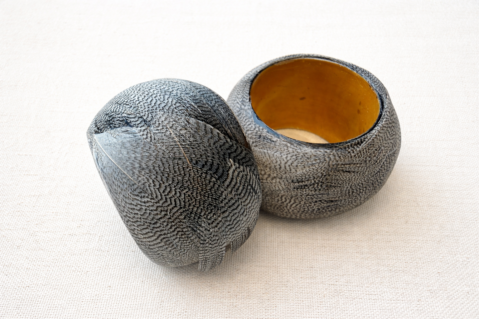 Handcrafted wooden bowls with vibrant interiors.png