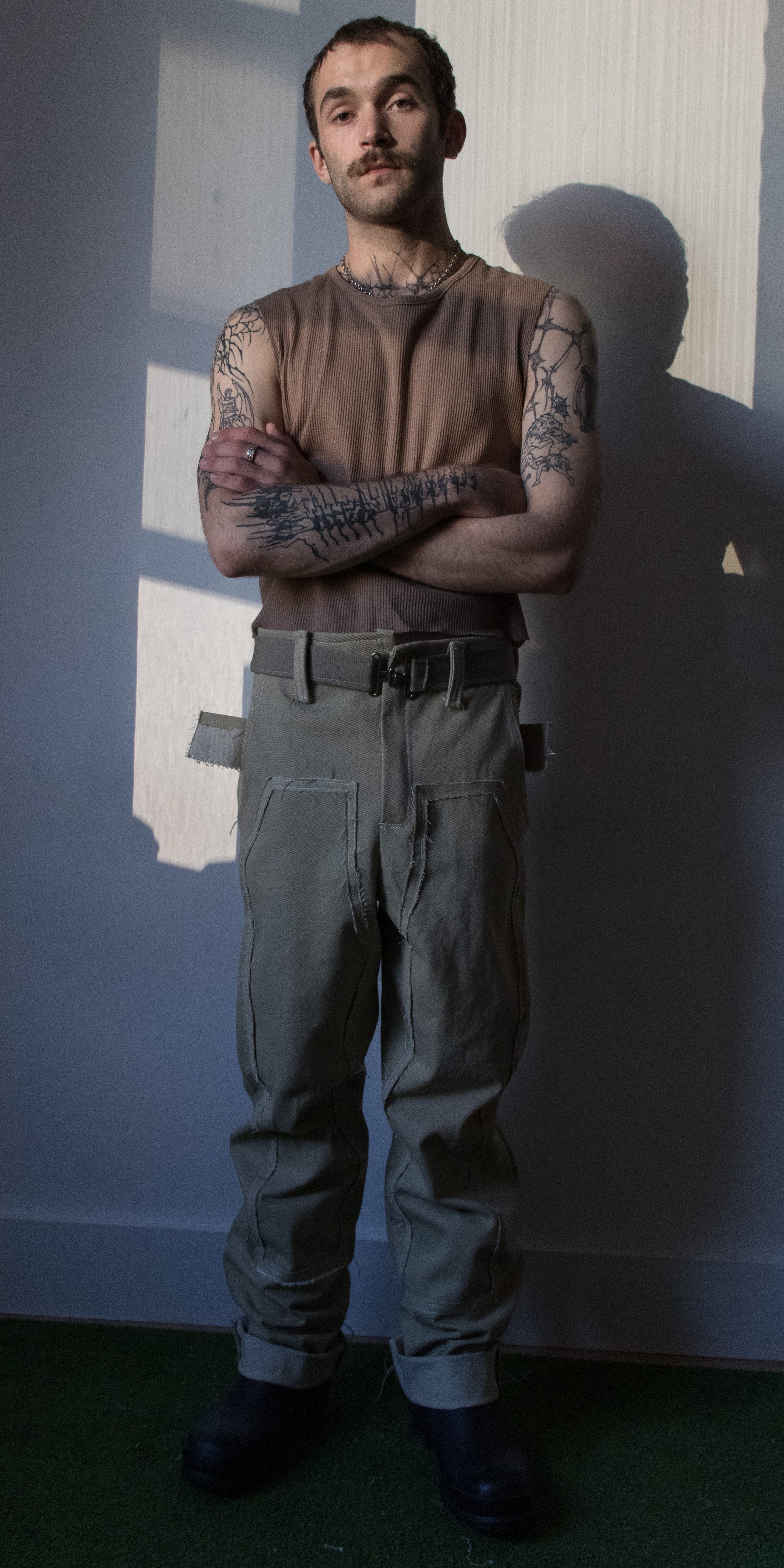 grant philips wearing thermal knit tank green work pantsby conor odriscoll defective workwear collection 2022