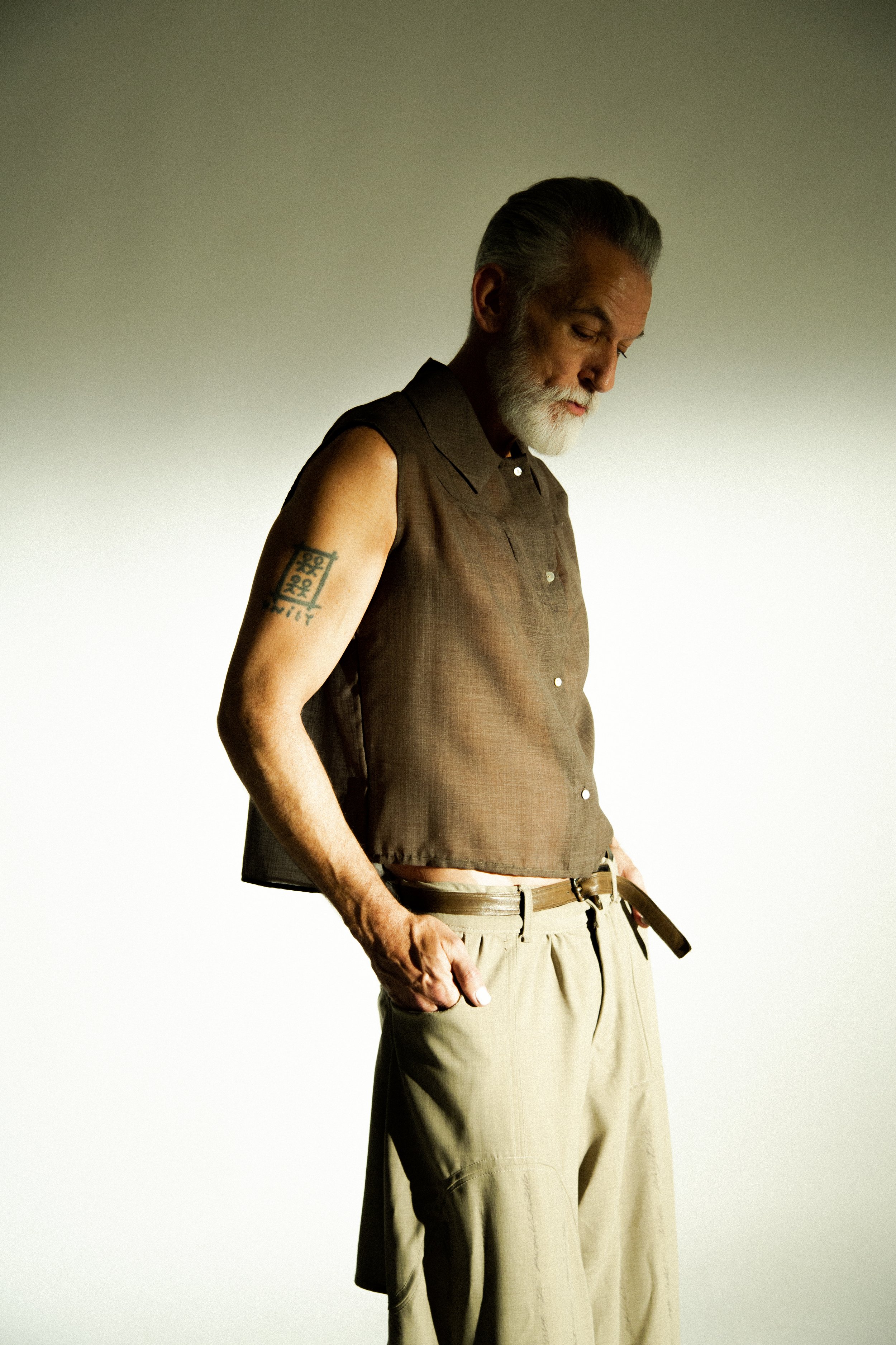 david hand in wrinkled wool two tone dirt coat, sleeveless wool dress shirt and wool dirt dipped love pants from sexual narcissist collection. look one waiting for my lover by conor odriscoll. shot by timothy cheng. new york city.