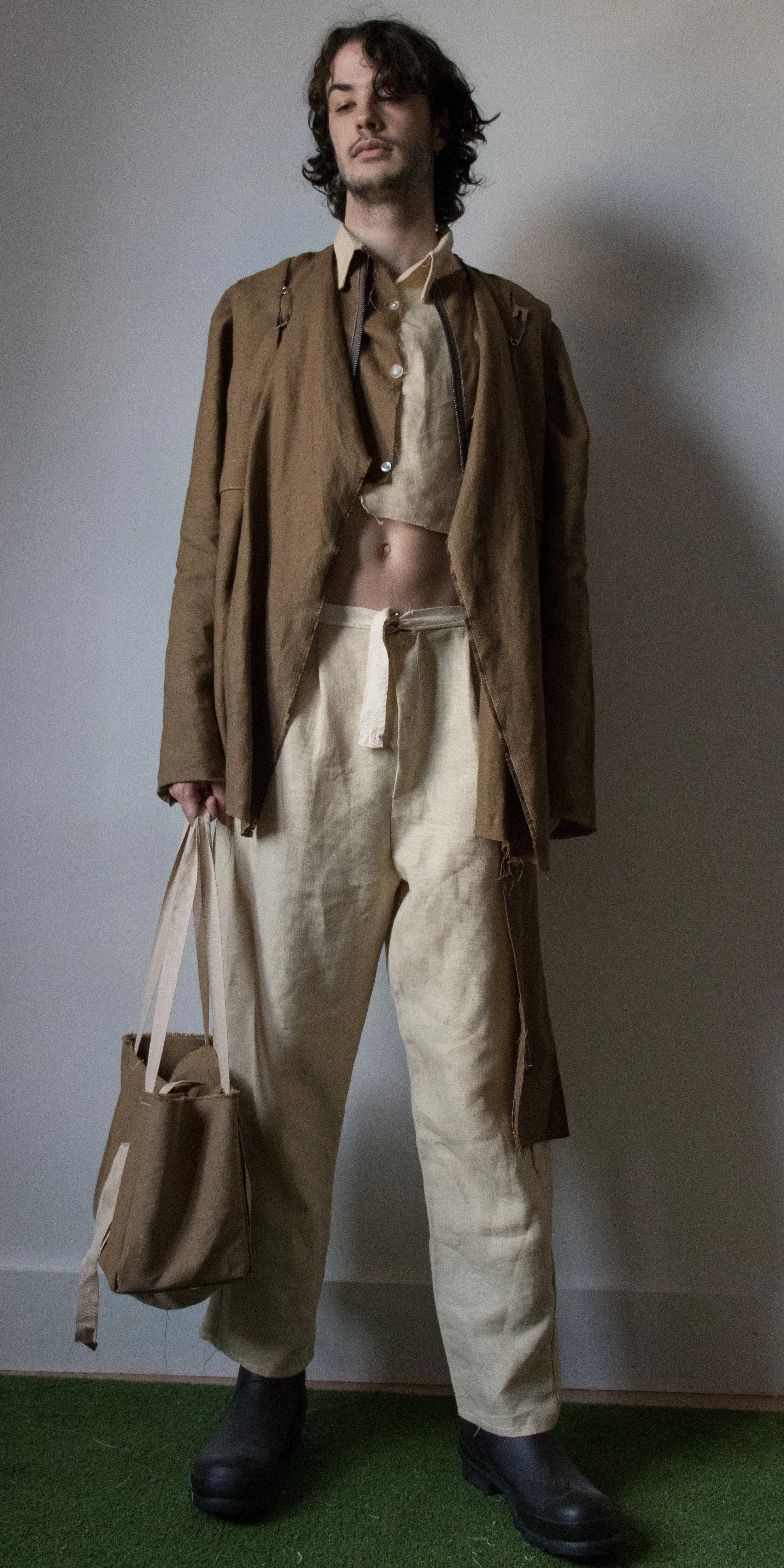 darcy wearing two toned linen dress shirt linen draped jacket and linen pants suede work bag  by conor odriscoll for defective workwear collection conor o'driscoll new york city nyc