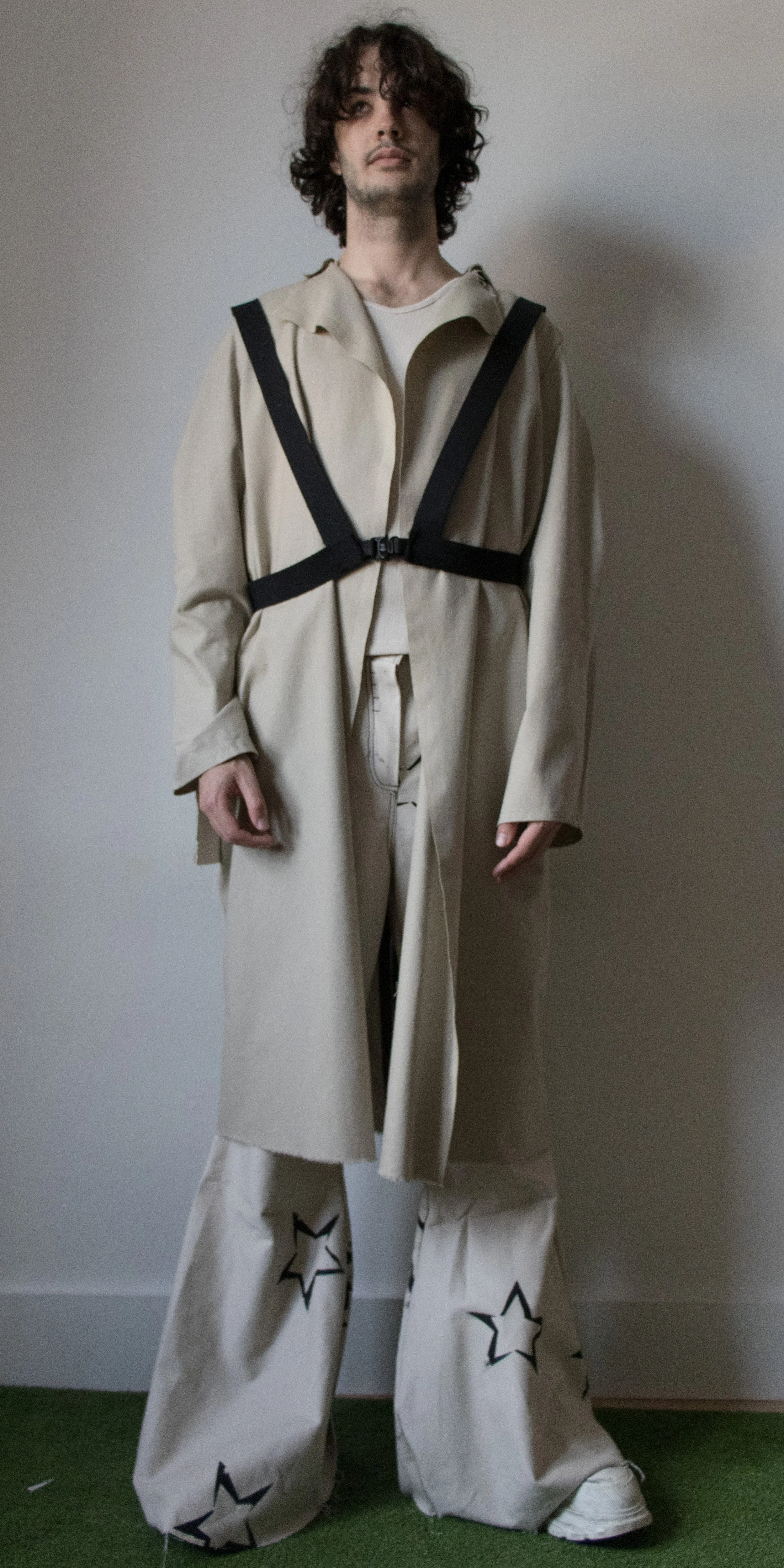 darcy wearing draped pleated coat star flared pants and office dress shirt harness by conor odriscoll for defective workwear collection conor o'driscoll new york city nyc