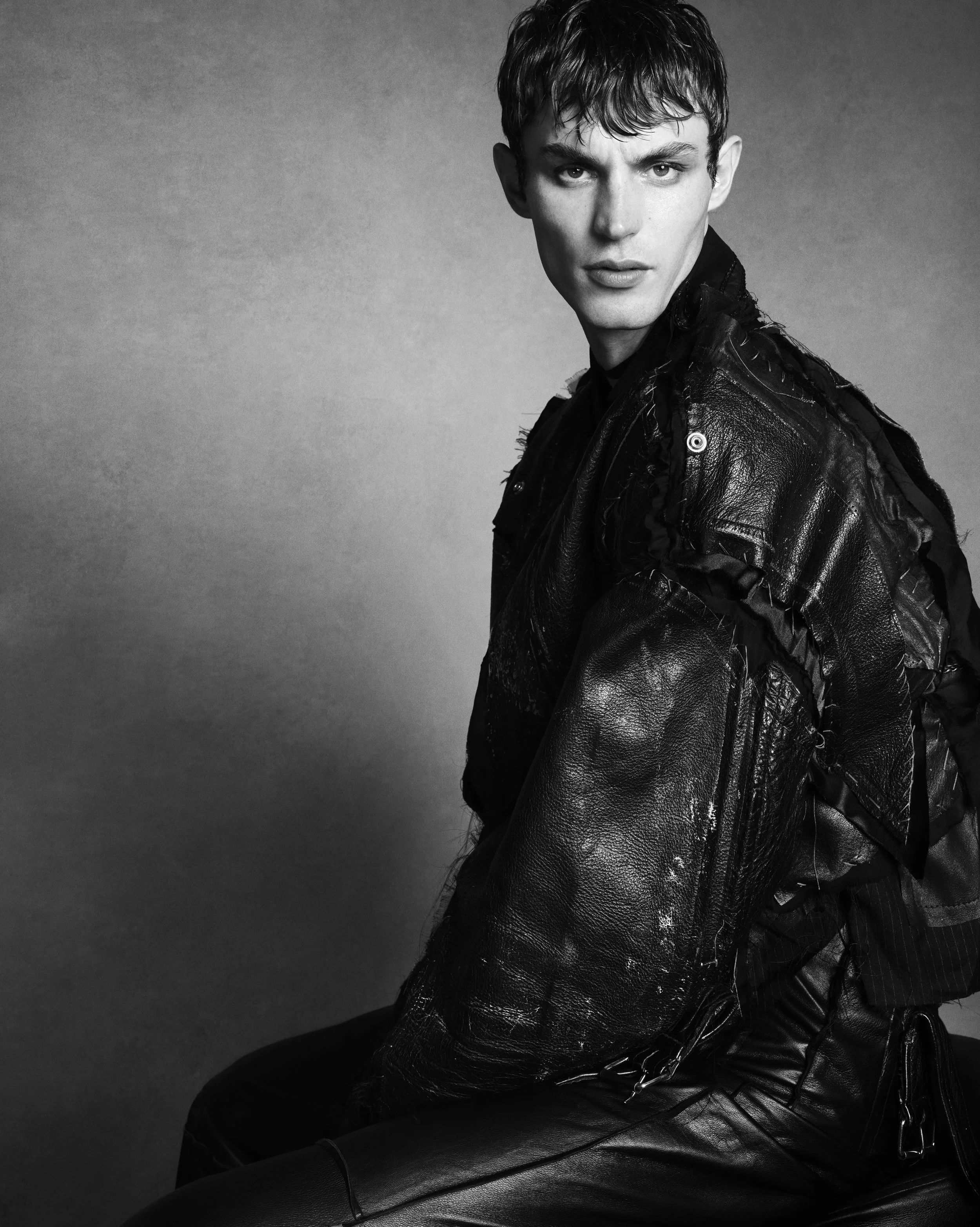 kit butler conor odriscol double vision luigi and iango KIT BUTLER with short hair, wearing a leather jacket, looking at the camera against a plain background. Conor O'Driscoll