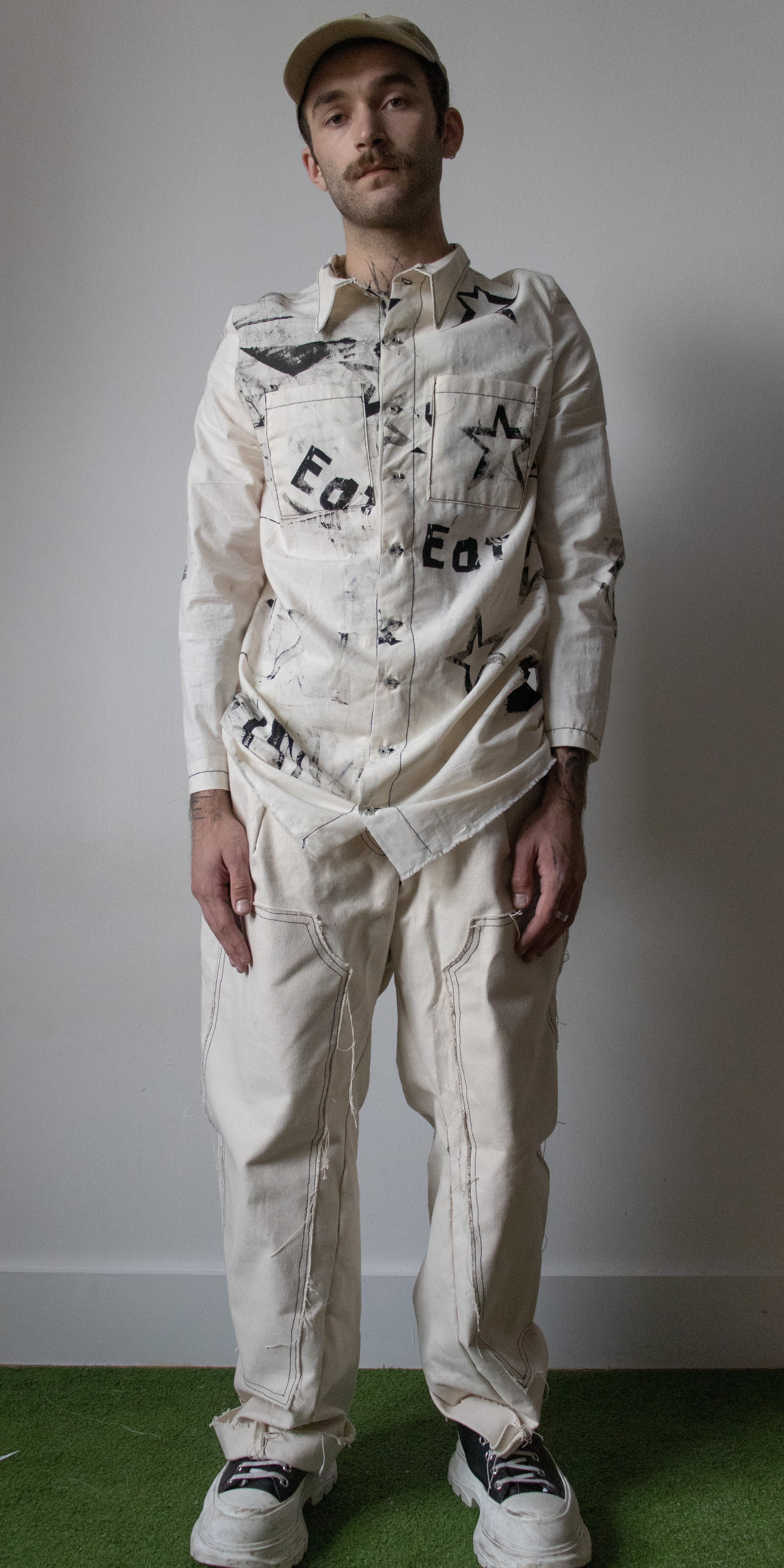 grant philips wearing eat consumption printed dress shirt and work pants by conor odriscoll defective workwear collection 2022