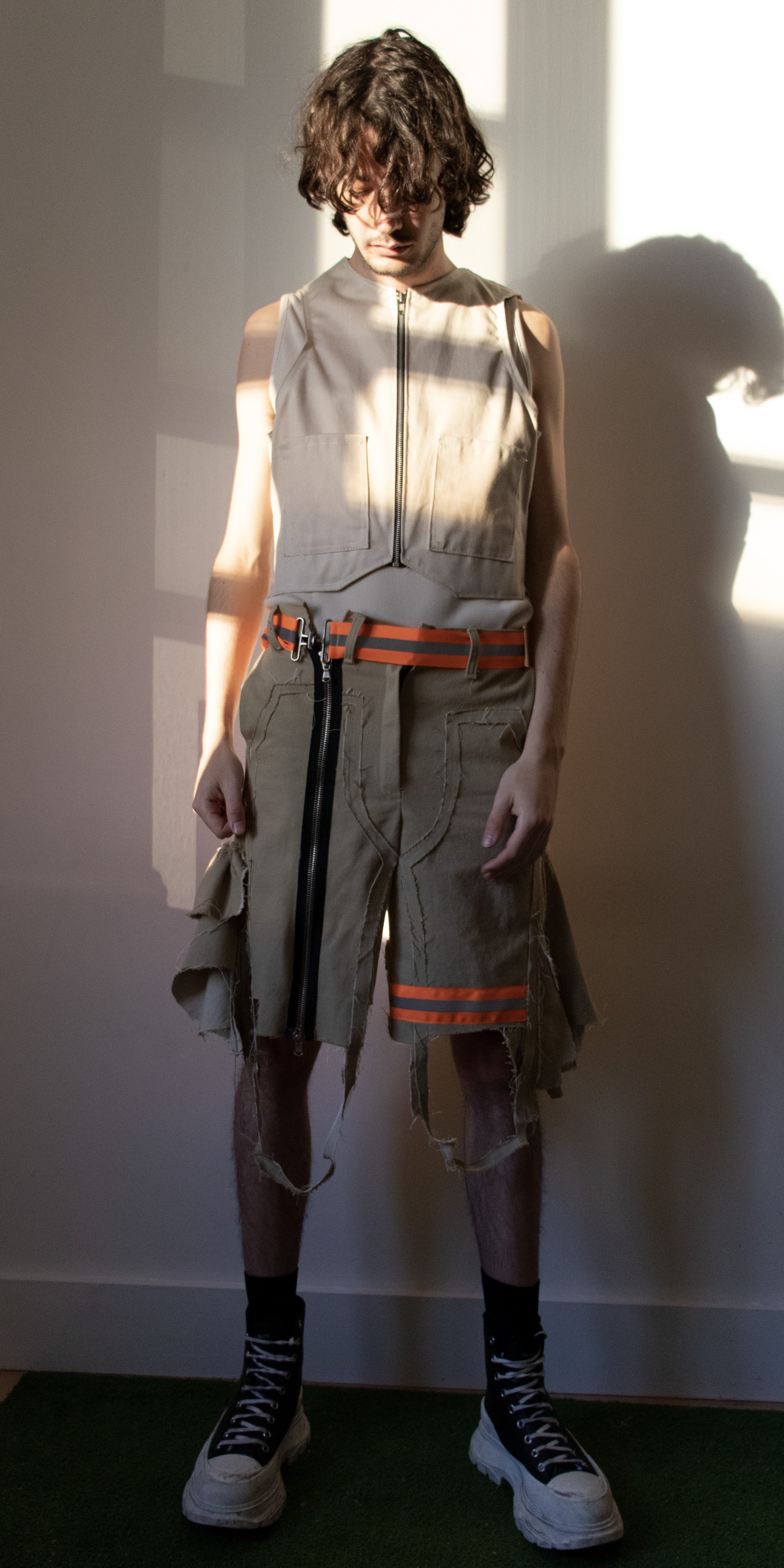 darcy wearing office tank top work vest and adjustable work shorts by conor odriscoll for defective workwear collection conor o'driscoll new york city nyc